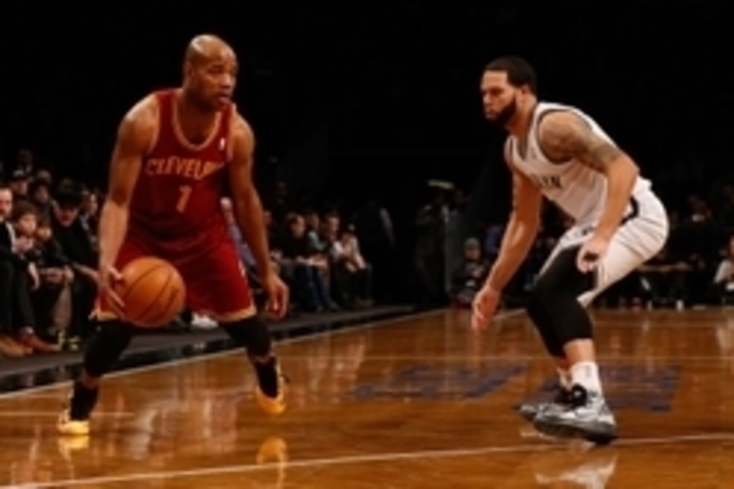 Jan 4, 2014; Brooklyn, NY, USA;  Cleveland Cavaliers point guard Jarrett Jack (1) readies to drive around Brooklyn Nets point guard Deron Williams (8) during the first quarter at Barclays Center. Mandatory Credit: Anthony Gruppuso-USA TODAY Sports