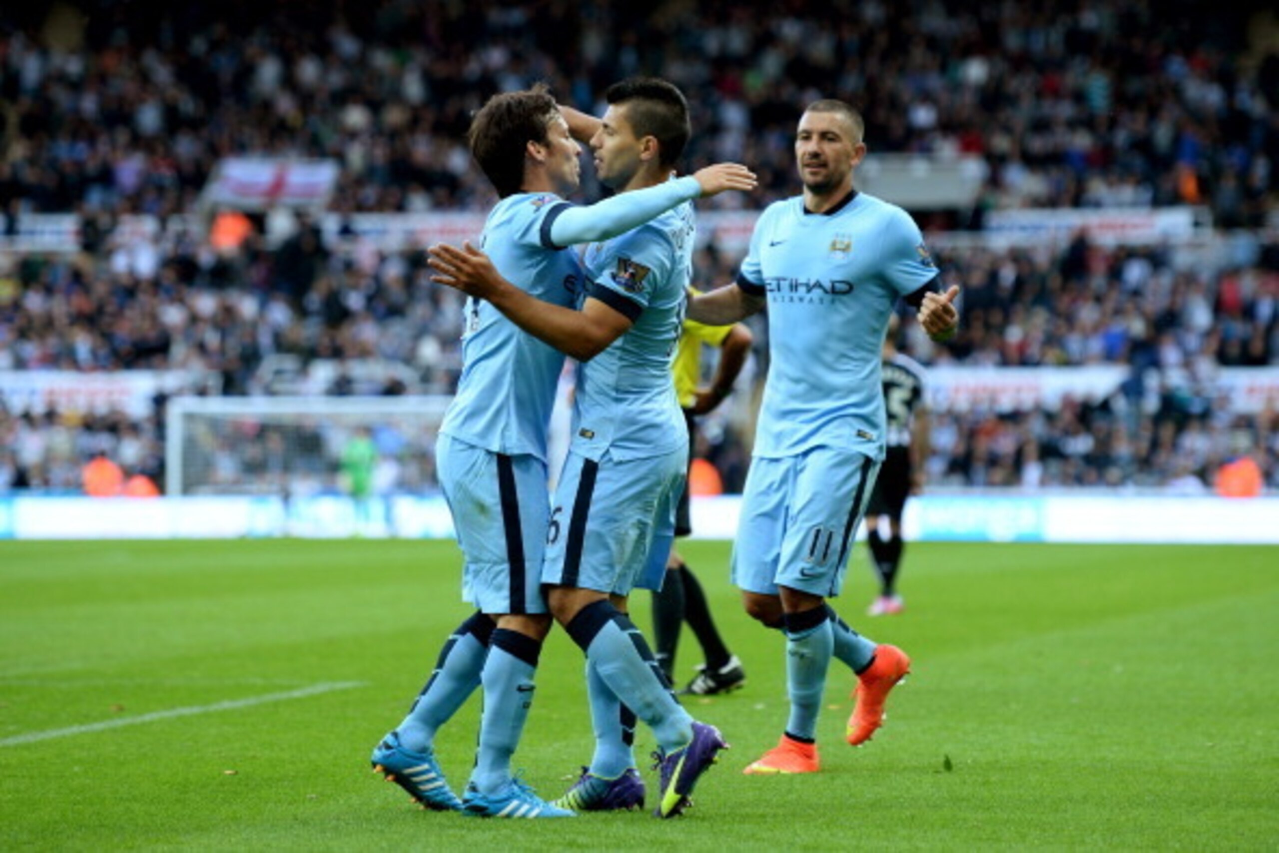 NEWCASTLE UPON TYNE, ENGLAND - AUGUST 17:  Sergio Aguero of Manchester City celebrates with teammates David Silva (L) and Aleksandr Kolarov (R) celebrates after scoring his team's second goal during the Barclays Premier League match between Newcastle Unit