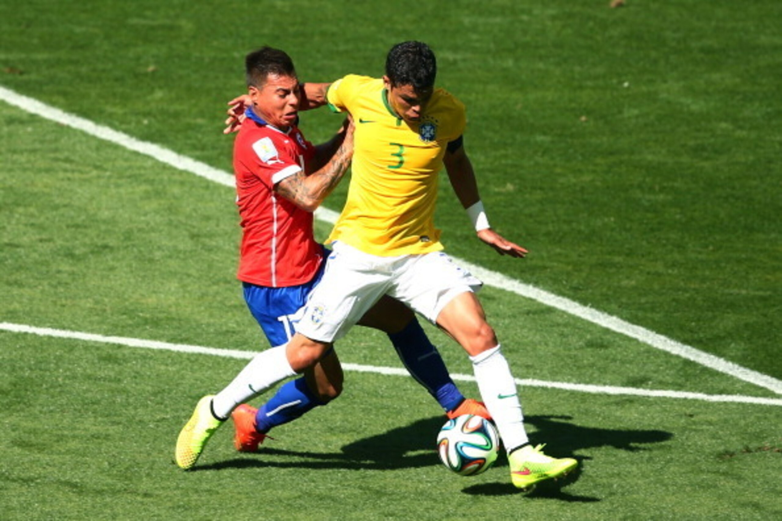BELO HORIZONTE, BRAZIL - JUNE 28:  Eduardo Vargas of Chile challenges Thiago Silva of Brazil during the 2014 FIFA World Cup Brazil round of 16 match between Brazil and Chile at Estadio Mineirao on June 28, 2014 in Belo Horizonte, Brazil.  (Photo by Ian Wa