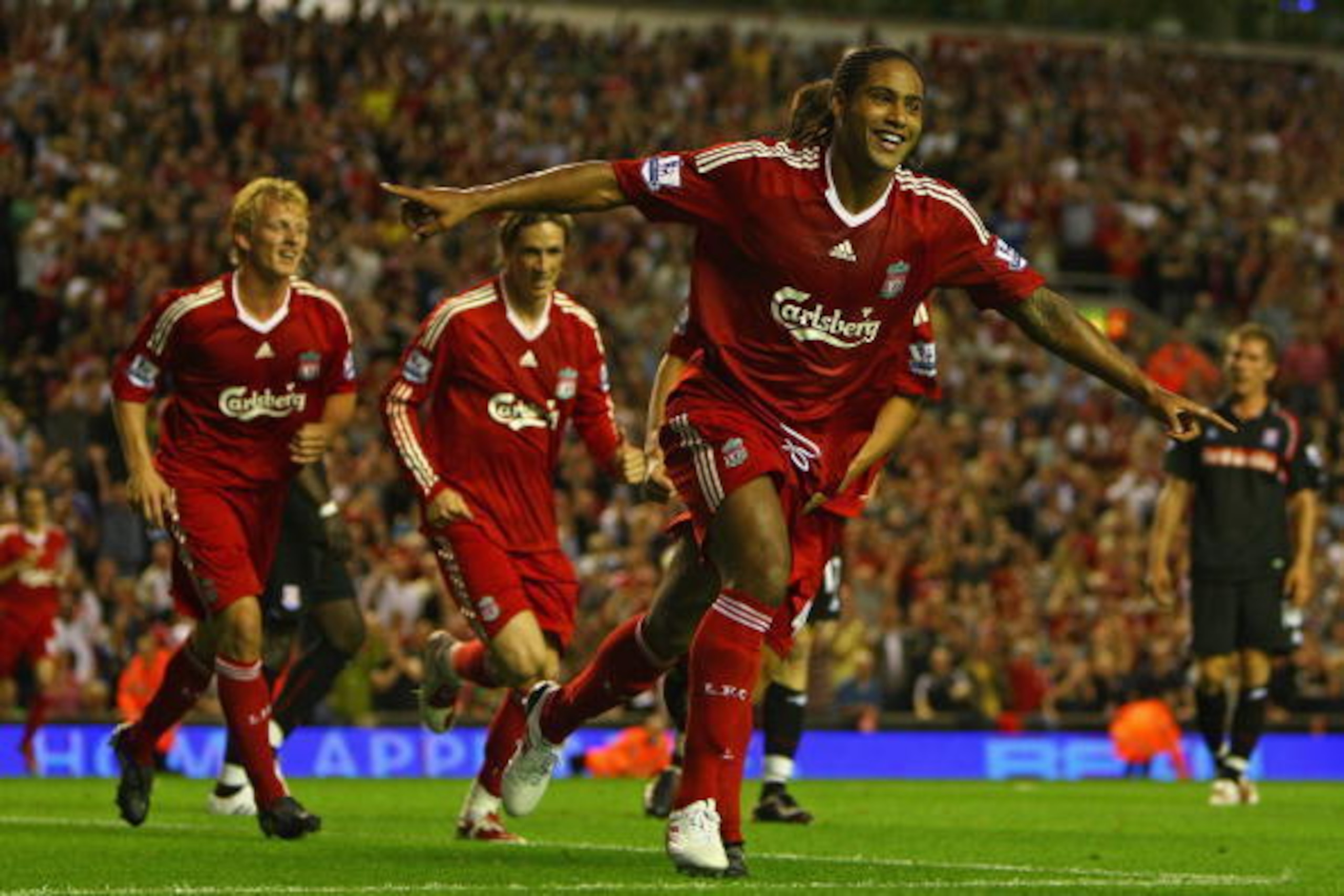 LIVERPOOL, ENGLAND - AUGUST 19:  Glen Johnson of Liverpool celebrates scoring his team's second goal during the Barclays Premier League match between Liverpool and Stoke City at Anfield on August 19, 2009 in Liverpool, England.  (Photo by Clive Brunskill/