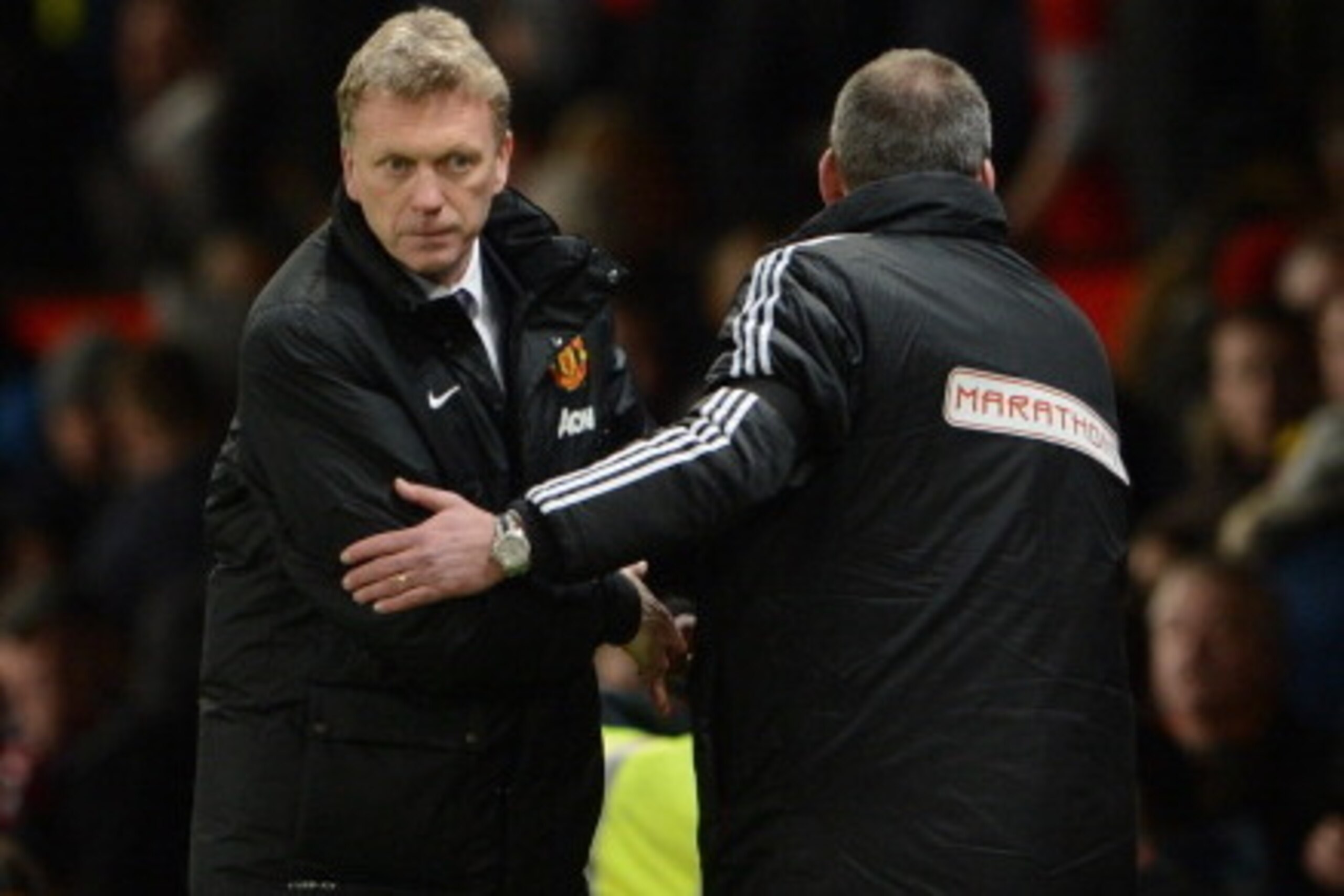 MANCHESTER, ENGLAND - FEBRUARY 09:  Fulham Manager Rene Meulensteen shakes hands with David Moyes of Manchester United at the end of the Barclays Premier League match between Manchester United and Fulham at Old Trafford on February 9, 2014 in Manchester, 