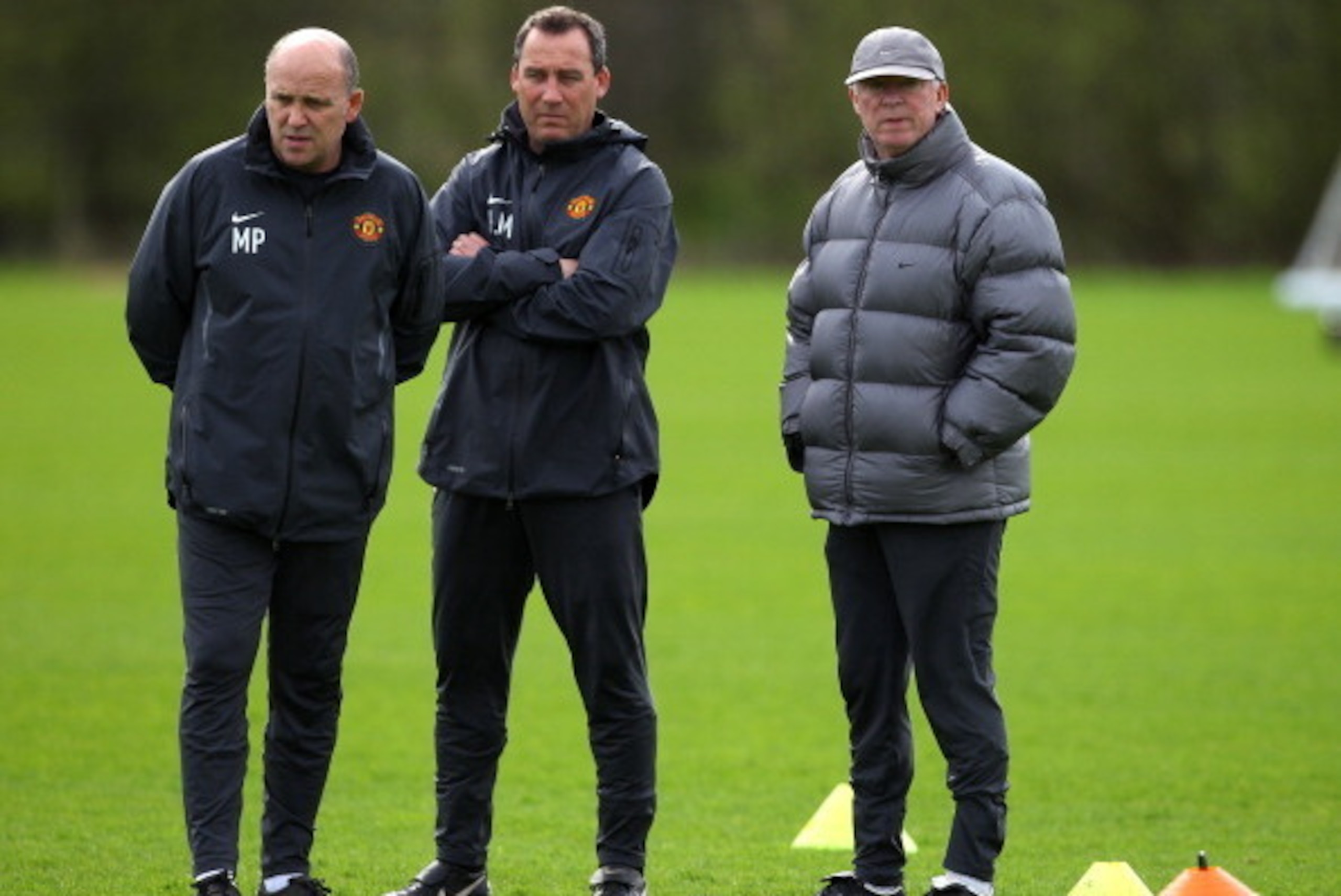 MANCHESTER, ENGLAND - APRIL 05:  Sir Alex Ferguson the manager of Manchester United looks on with Rene Meulensteen (c) and Mike Phelan his assistant (l) during a Manchester United training session ahead of the UEFA Champions League quarter-final first leg