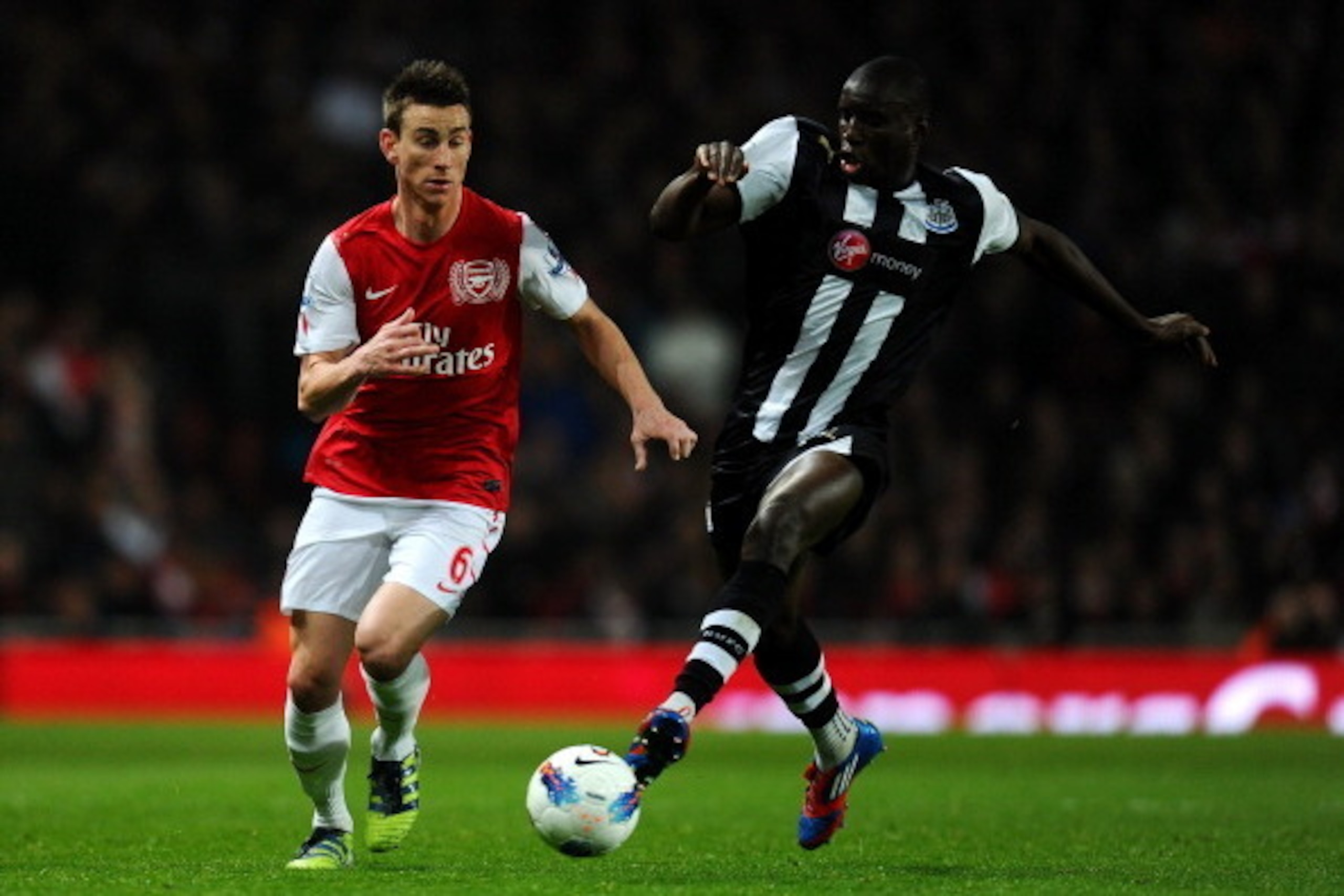 LONDON, ENGLAND - MARCH 12:  Laurent Koscielny of Arsenal and Demba Ba of Newcastle battle for the ball during the Barclays Premier League match between Arsenal and Newcastle United at Emirates Stadium on March 12, 2012 in London, England.  (Photo by Mike