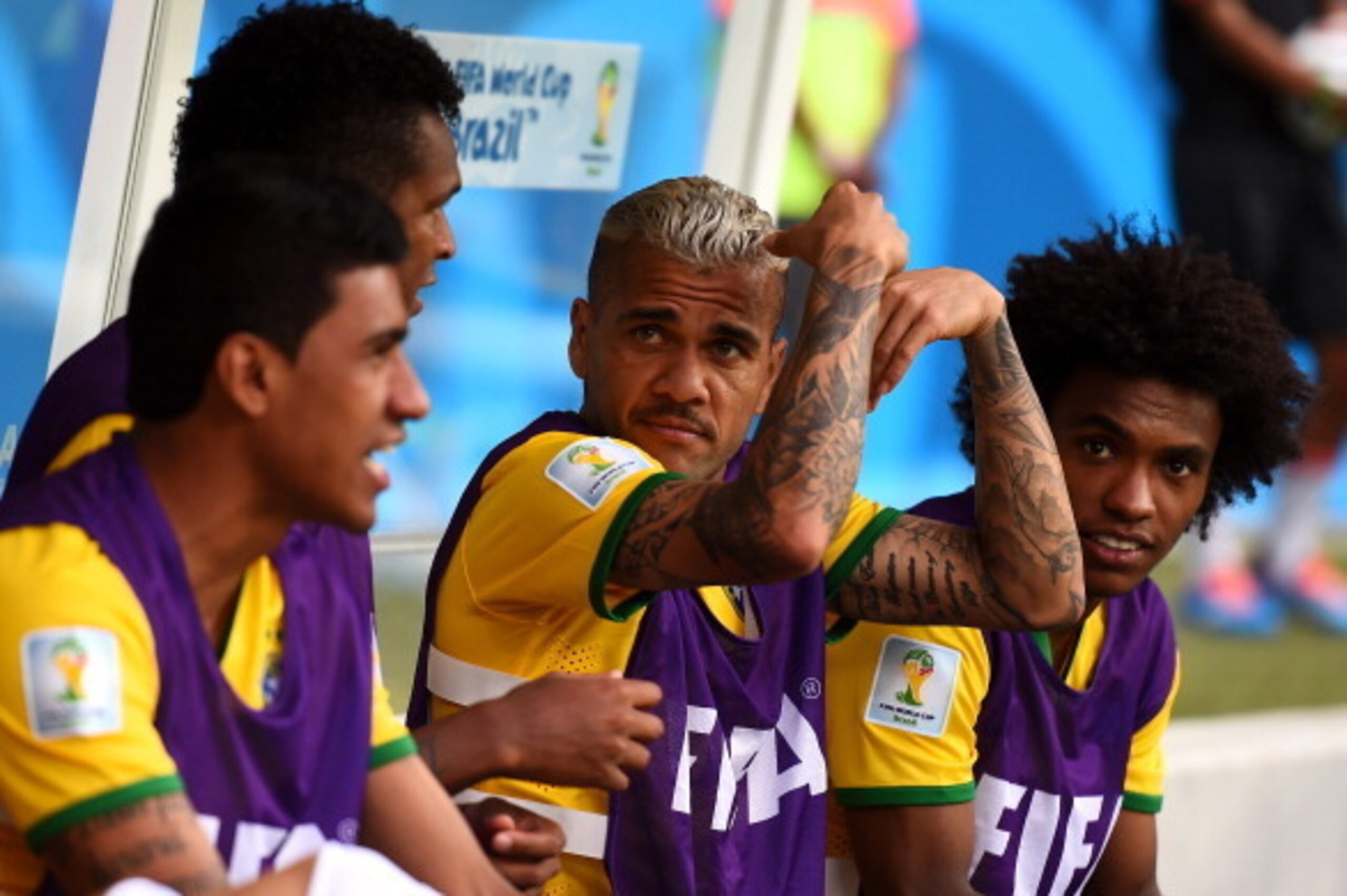 BELO HORIZONTE, BRAZIL - JULY 08:  Dani Alves of Brazil looks on from the bench with teammates during the 2014 FIFA World Cup Brazil Semi Final match between Brazil and Germany at Estadio Mineirao on July 8, 2014 in Belo Horizonte, Brazil.  (Photo by Laur