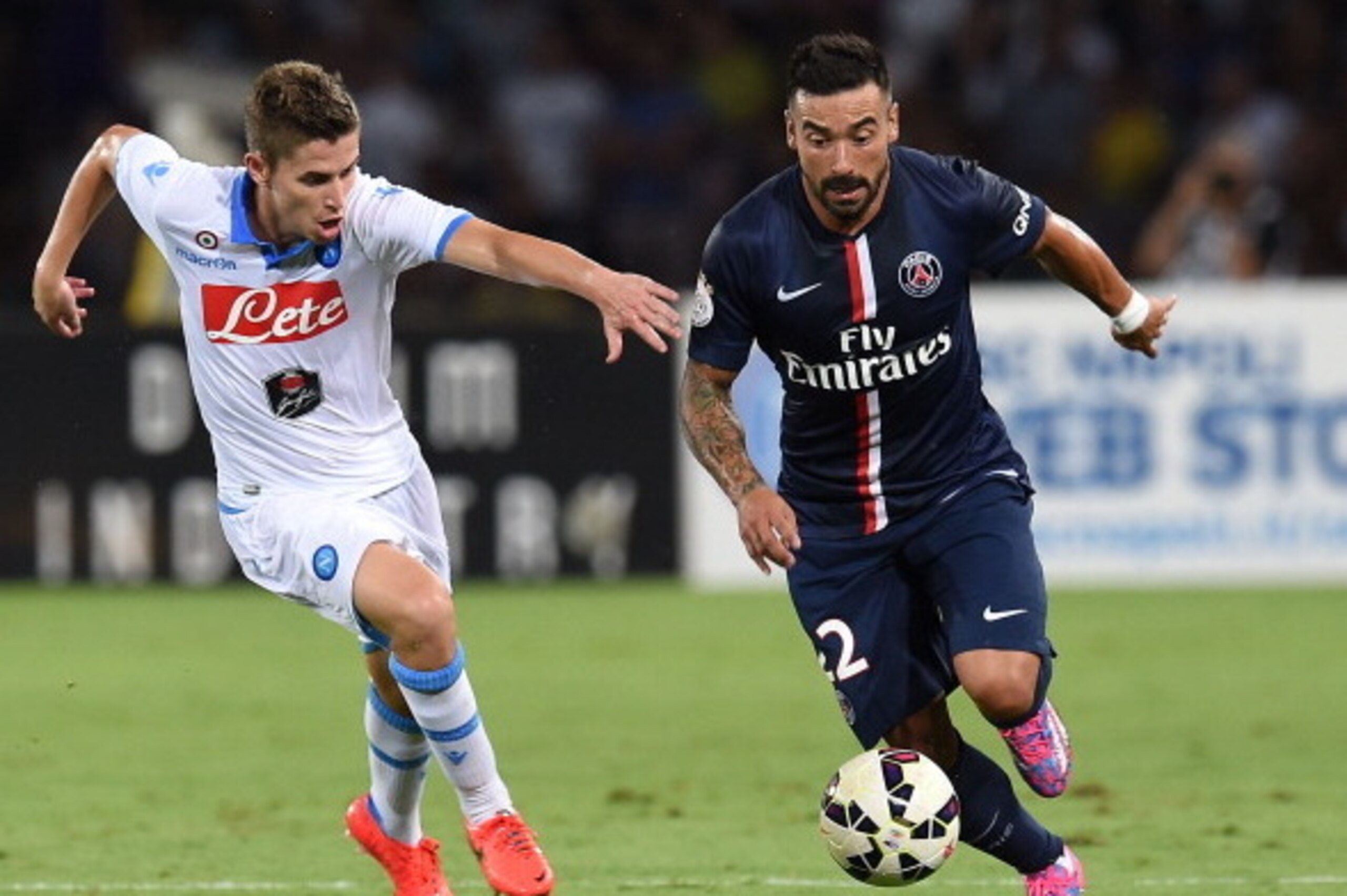 NAPLES, ITALY - AUGUST 11: Jorginho of Napoli and Ezequiel Lavezzi  of Paris Saint Germain in action during the pre-season friendly match between SSC Napoli and Paris Saint-Germain FC at Stadio San Paolo on August 11, 2014 in Naples, Italy.  (Photo by Giu