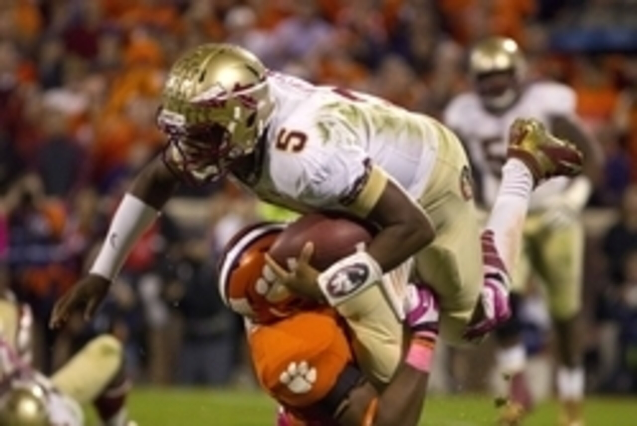 Oct 19, 2013; Clemson, SC, USA; Florida State Seminoles quarterback Jameis Winston (5) is brought down by Clemson Tigers safety Travis Blanks (11) during the first half at Clemson Memorial Stadium. Mandatory Credit: Joshua S. Kelly-USA TODAY Sports
