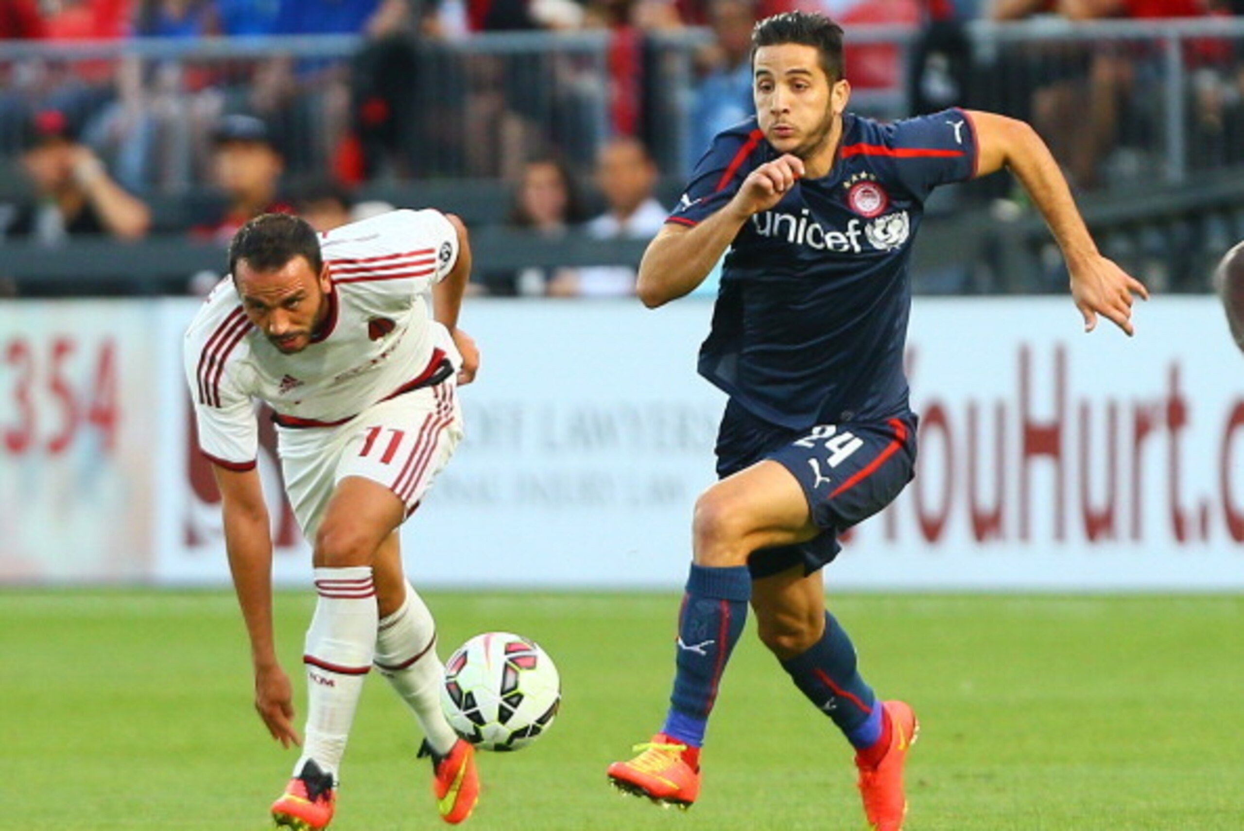 TORONTO, ON - JULY 24: Giampaolo Pazzini #11 of AC Milan chases the ball against Kostas Manolas #24 of Olympiacos FC during International Champions Cup 2014 action at BMO Field July 24, 2014 in Toronto, Ontario, Canada.  (Photo by Abelimages/Getty Images)