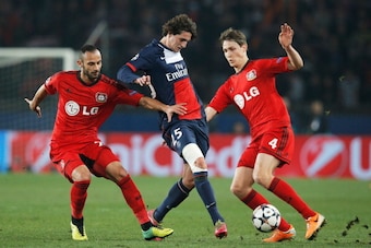 PARIS, FRANCE - MARCH 12:  Adrien Rabiot of Paris Saint-Germain (C) battles with Omer Toprak (L) and Philipp Wollscheid of Bayer Leverkusen (R) during the UEFA Champions League Round of 16 second leg match between Paris Saint-Germain FC and Bayer Leverkus