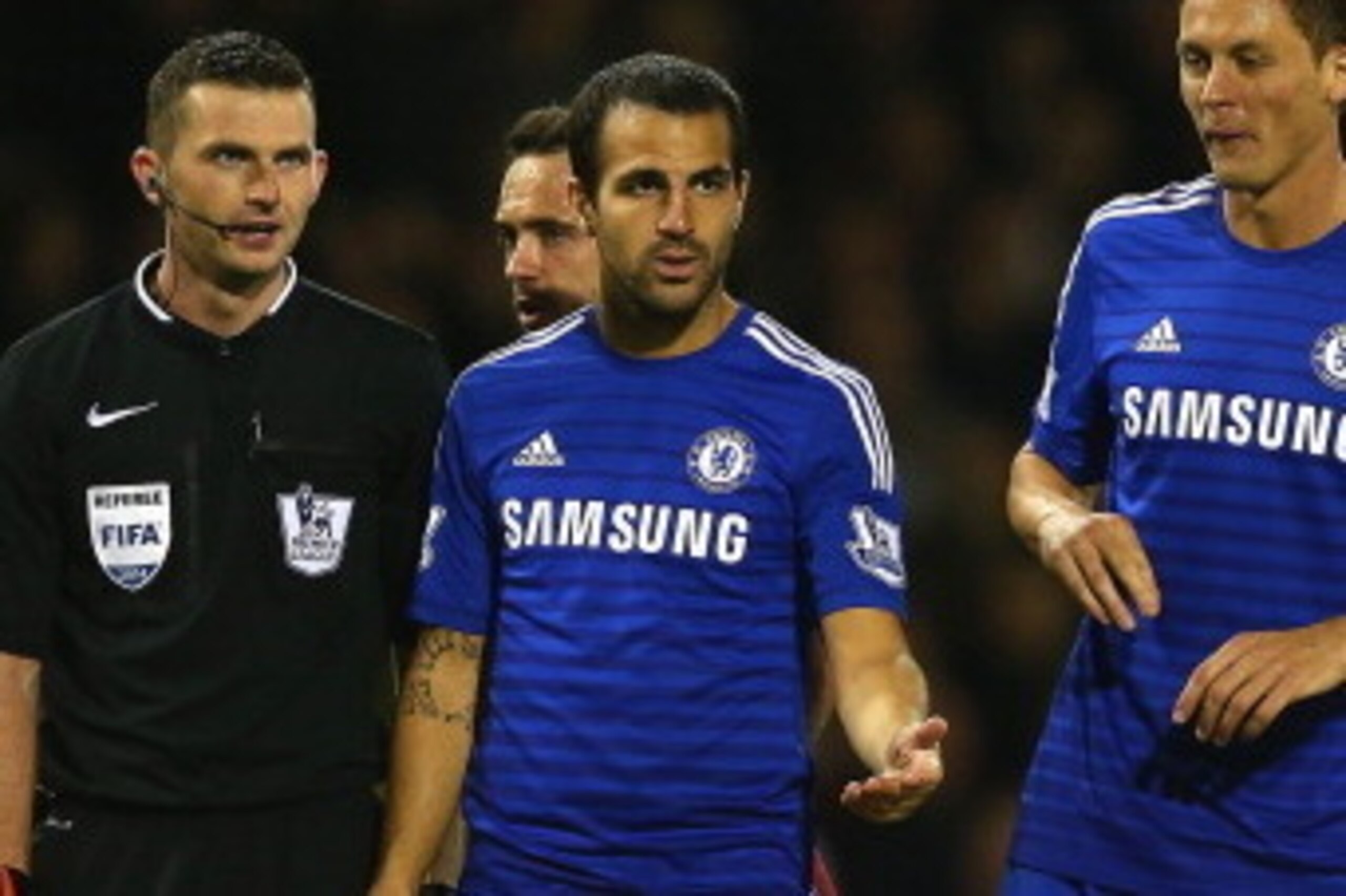 BURNLEY, ENGLAND - AUGUST 18:   Referee Michael Oliver speaks to Cesc Fabregas and Nemanja Matic of Chelsea during the Barclays Premier League match between Burnley and Chelsea at Turf Moor on August 18, 2014 in Burnley, England.  (Photo by Clive Brunskil