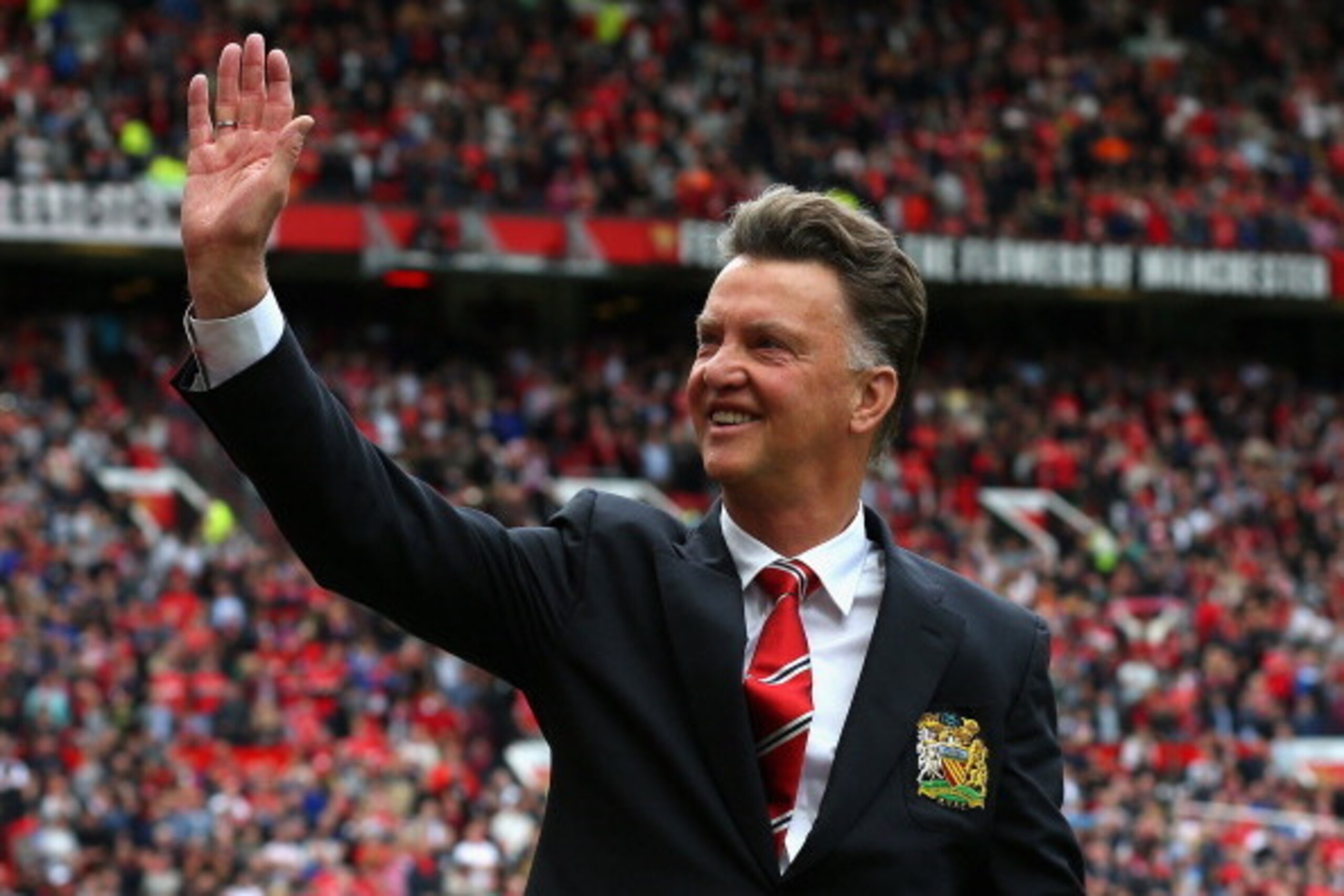 MANCHESTER, ENGLAND - AUGUST 16:  Manchester United Manager Louis van Gaal waves to the crowd prior to the Barclays Premier League match between Manchester United and Swansea City at Old Trafford on August 16, 2014 in Manchester, England.  (Photo by Alex 