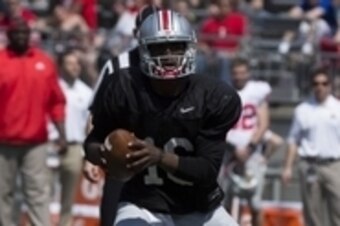 Apr 12, 2014; Columbus, OH, USA; Ohio State gray team quarterback J.T. Barrett (16) tucks the ball in to run it out of the backfield during the Ohio State Buckeyes spring game at Ohio Stadium. The scarlet team won the game 17-7. Mandatory Credit: Greg Bar