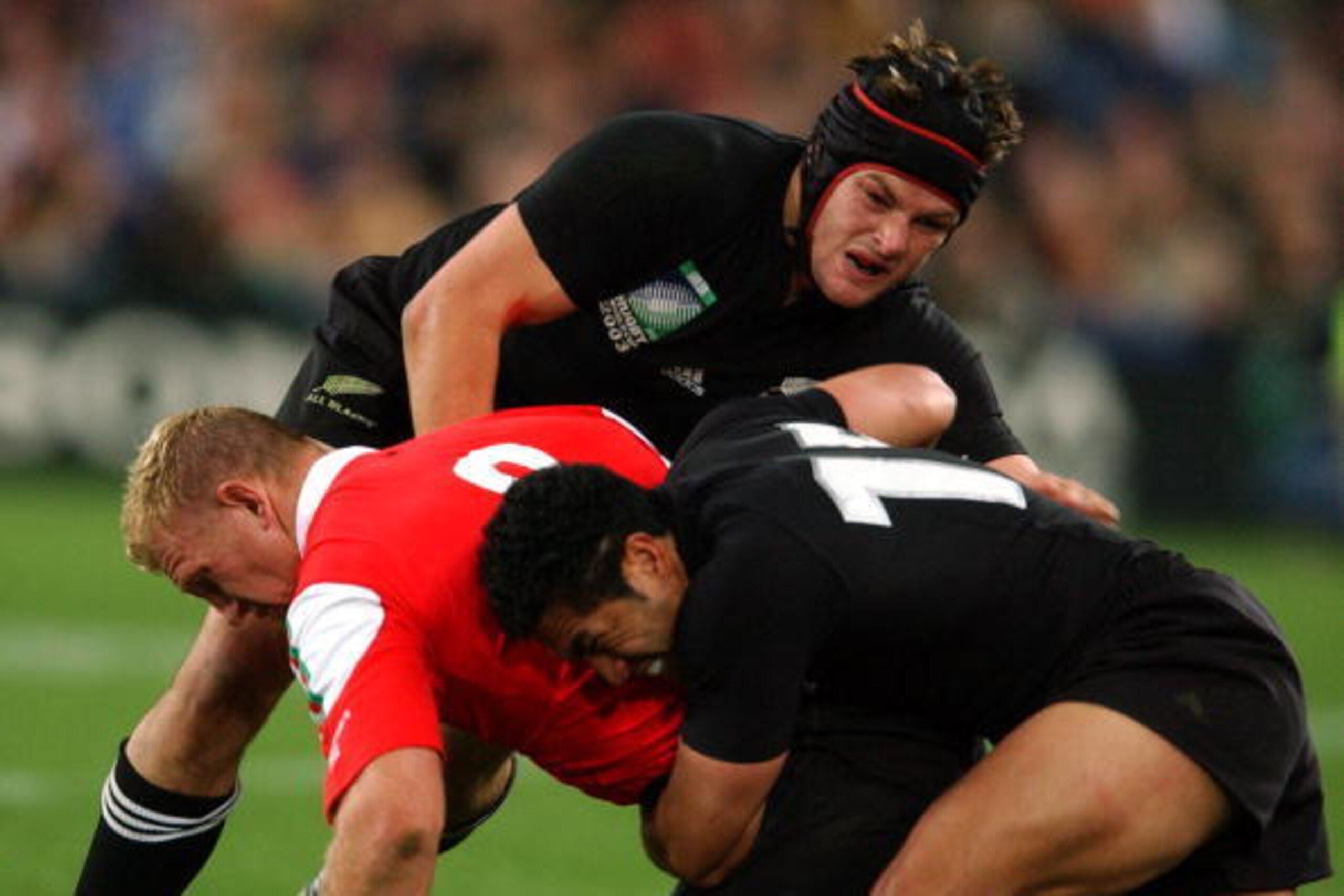 SYDNEY, AUSTRALIA - NOVEMBER 03:  All Blacks Richie McCaw (top) and Mils Muliaina tackle Welsh No8 Alix Popham during New Zealands' 5337 win over Wales in their Rugby World Cup Pool D match at the Olympic Stadium, Sydney, Sunday.  (Photo by Ross Land/Gett