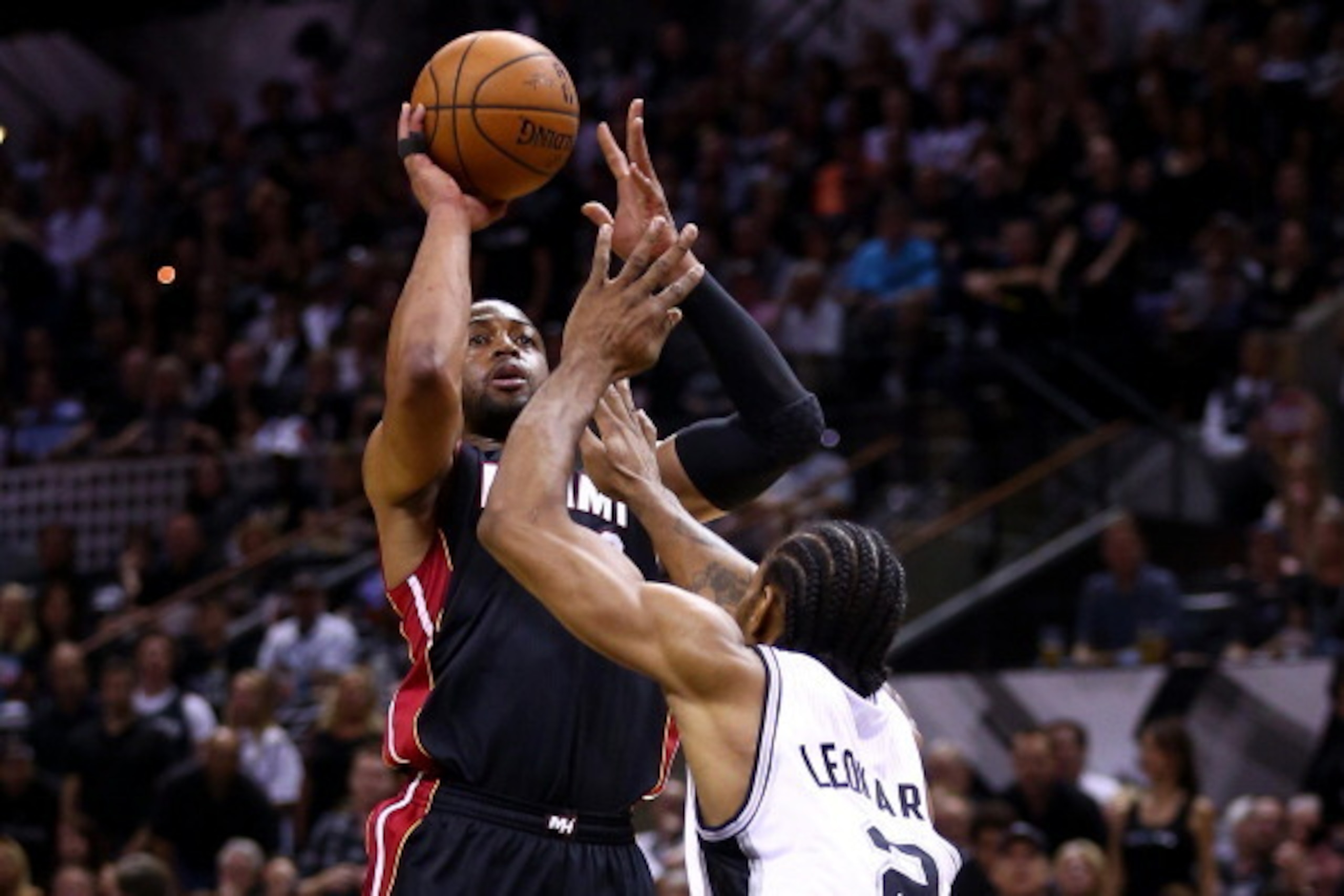 SAN ANTONIO, TX - JUNE 15: Dwyane Wade #3 of the Miami Heat takes a shot over Kawhi Leonard #2 of the San Antonio Spurs during Game Five of the 2014 NBA Finals at the AT&T Center on June 15, 2014 in San Antonio, Texas. NOTE TO USER: User expressly acknowl