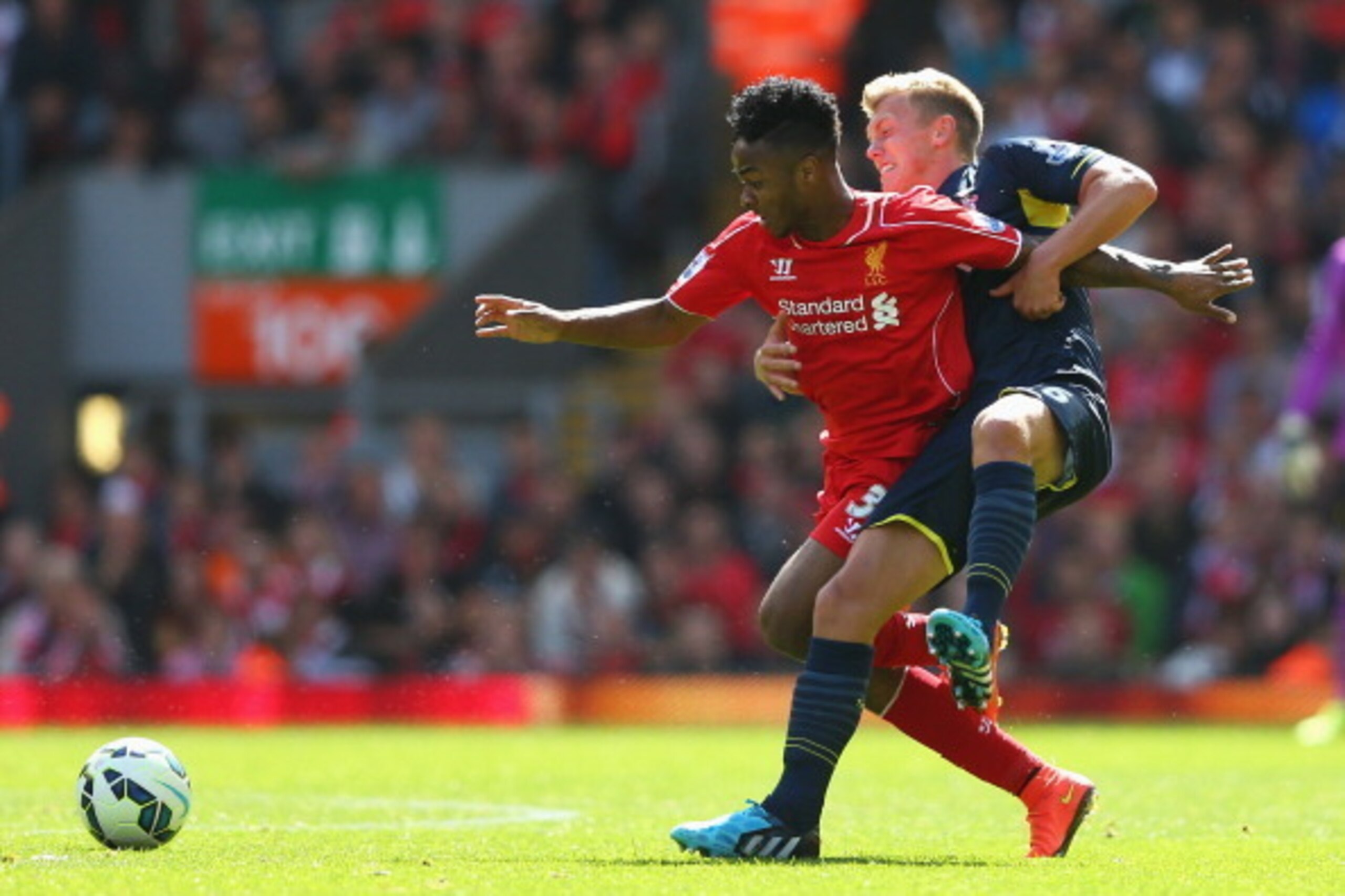 LIVERPOOL, ENGLAND - AUGUST 17: Raheem Sterling of Liverpool is challenged by James Ward-Prowse of Southampton during the Barclays Premier League match between Liverpool and Southampton at Anfield on August 17, 2014 in Liverpool, England.  (Photo by Alex 