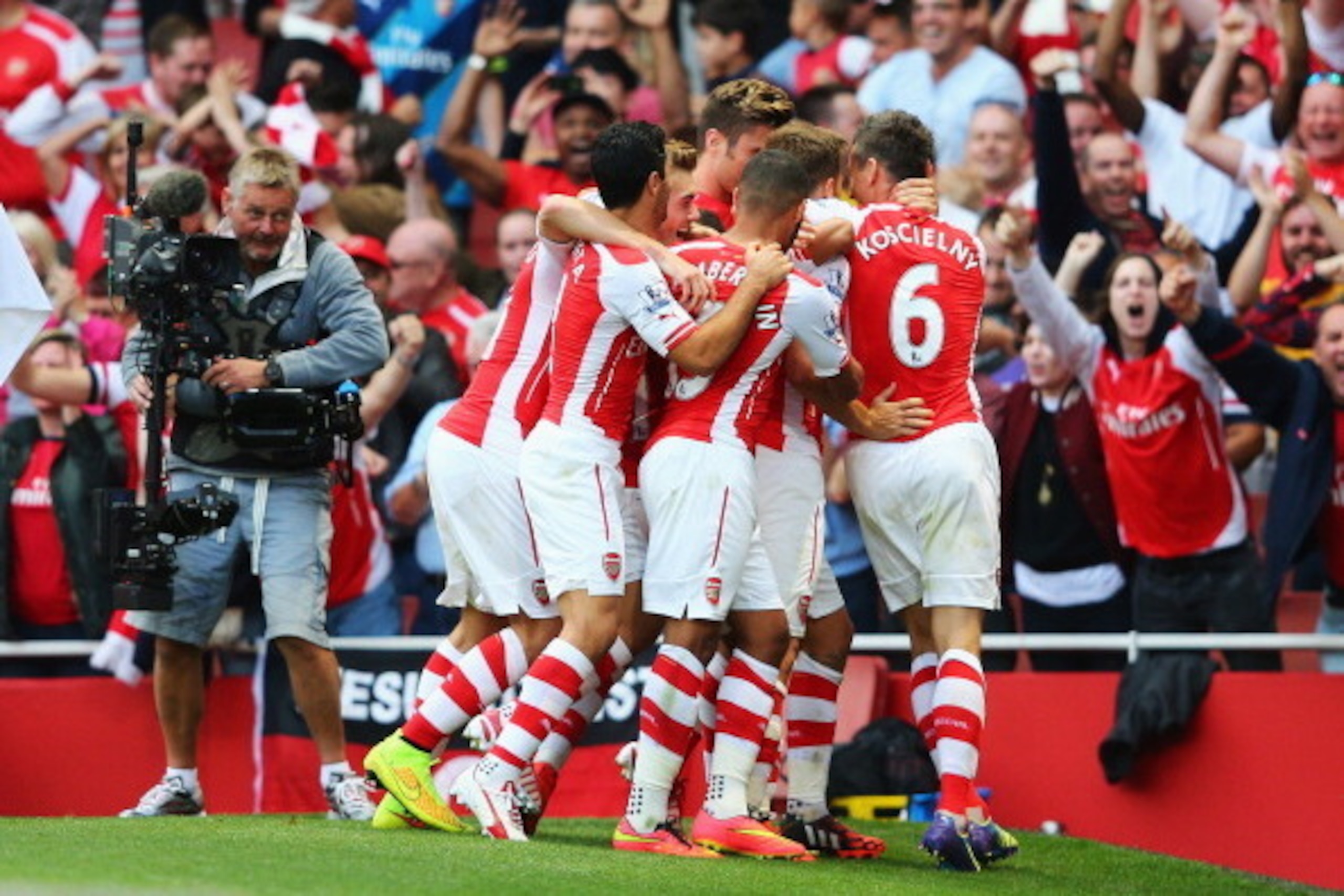 LONDON, ENGLAND - AUGUST 16:  Aaron Ramsey of Arsenal is mobbed by team mates after his goal during the Barclays Premier League match between Arsenal and Crystal Palace at Emirates Stadium on August 16, 2014 in London, England.  (Photo by Clive Mason/Gett
