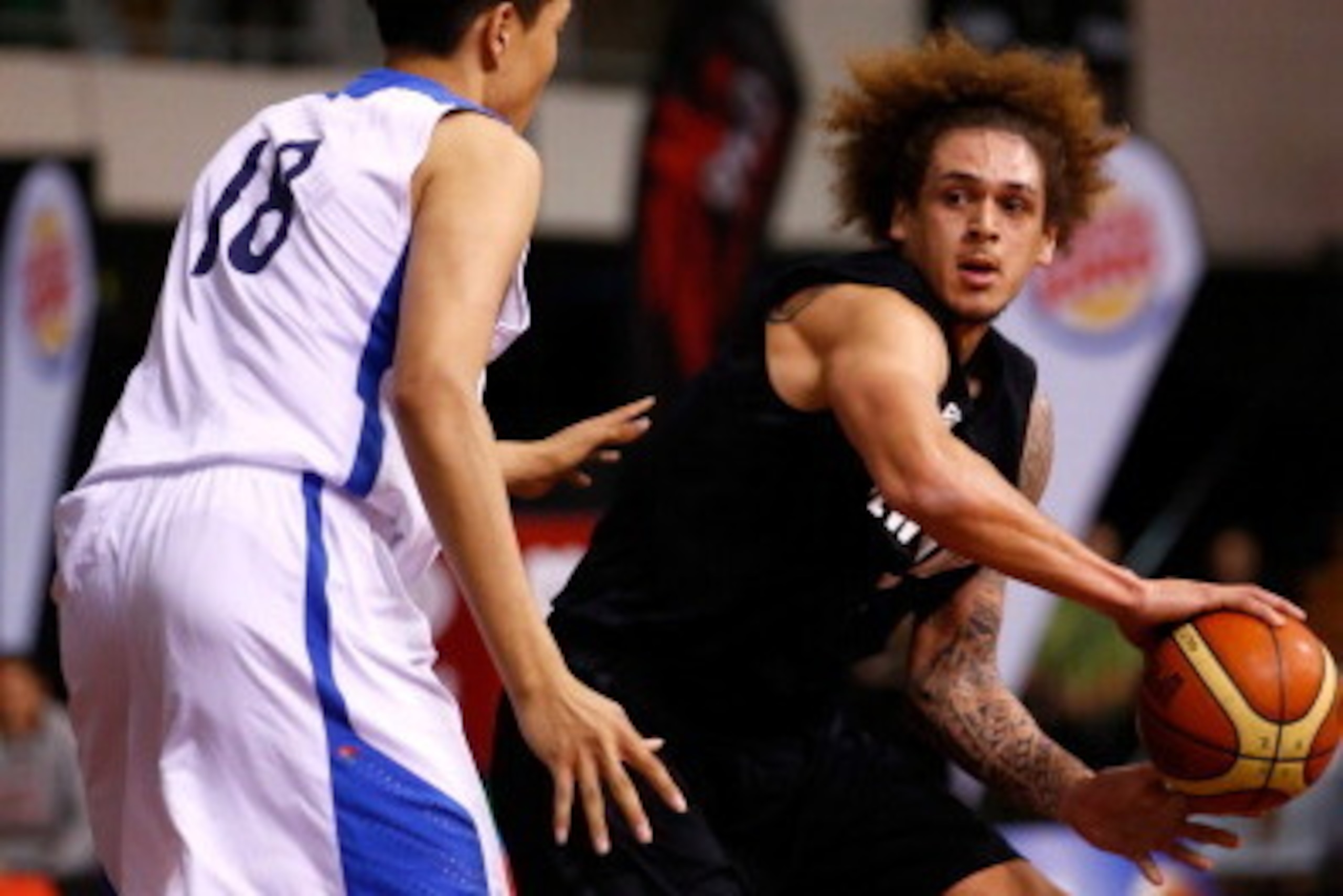AUCKLAND, NEW ZEALAND - JULY 19:  Isaac Fotu of New Zealand looks to pass the ball during the international match between the New Zealand Tall Blacks and South Korea at North Shore Events Centre on July 19, 2014 in Auckland, New Zealand.  (Photo by Phil W