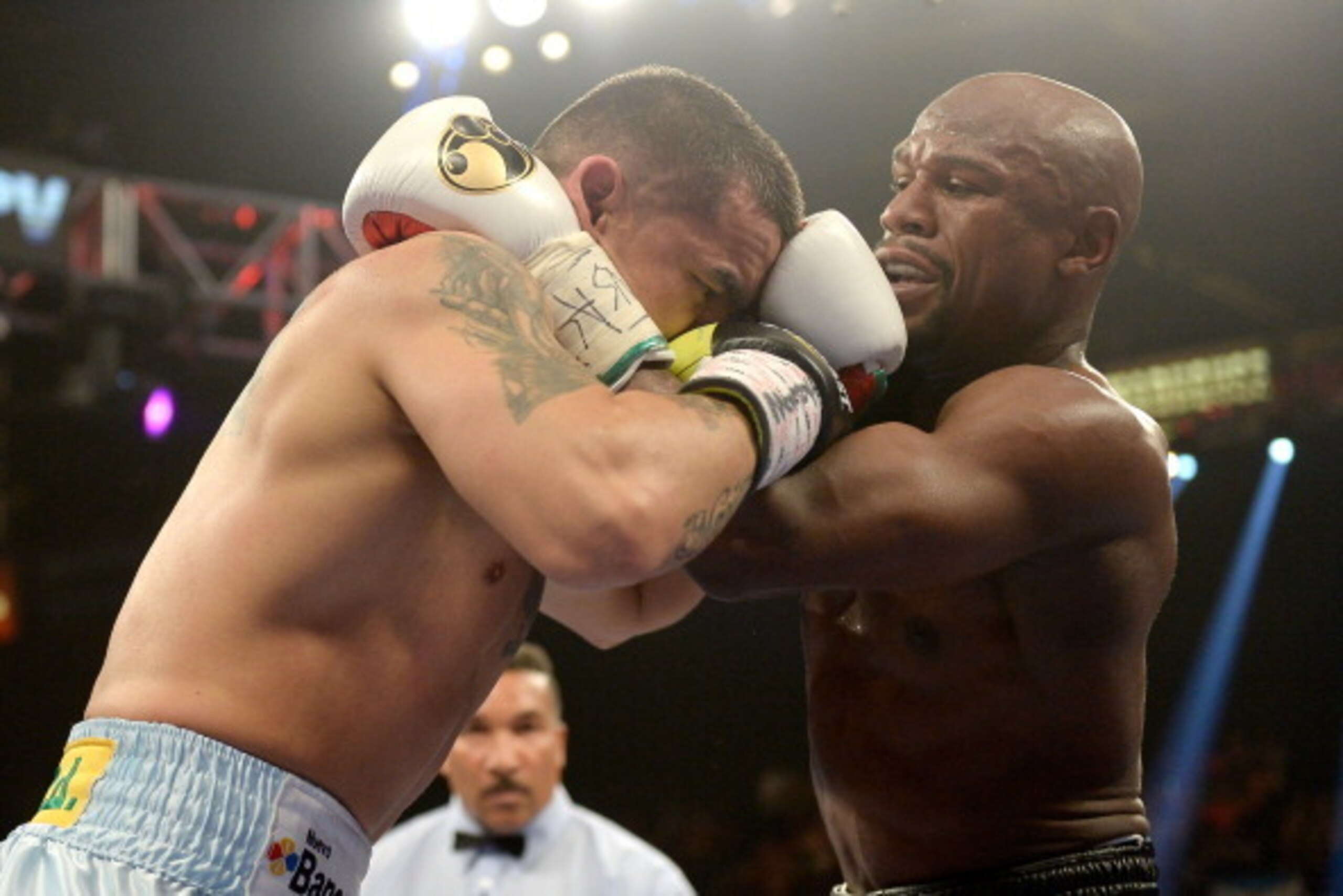 LAS VEGAS, NV - MAY 03:  (L-R) Marcos Maidana and  Floyd Mayweather Jr. hold during their WBC/WBA welterweight unification fight at the MGM Grand Garden Arena on May 3, 2014 in Las Vegas, Nevada.  (Photo by Harry How/Getty Images)