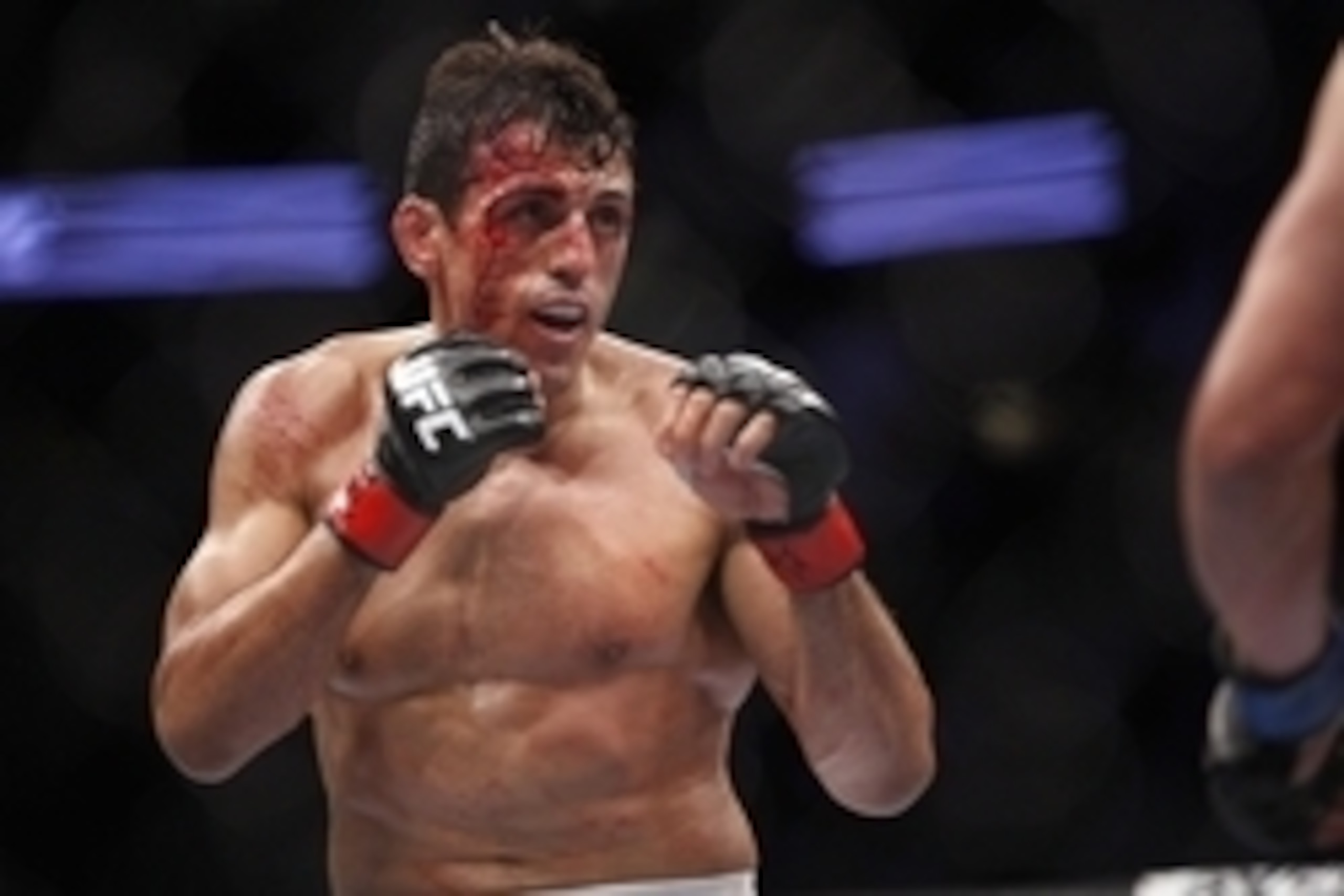 Oct 19, 2013; Houston, TX, USA; K.J. Noons (blue gloves) fights against George Sotiropoulos (red gloves) in their lightweight bout during UFC 166 at Toyota Center. Mandatory Credit: Andrew Richardson-USA TODAY Sports