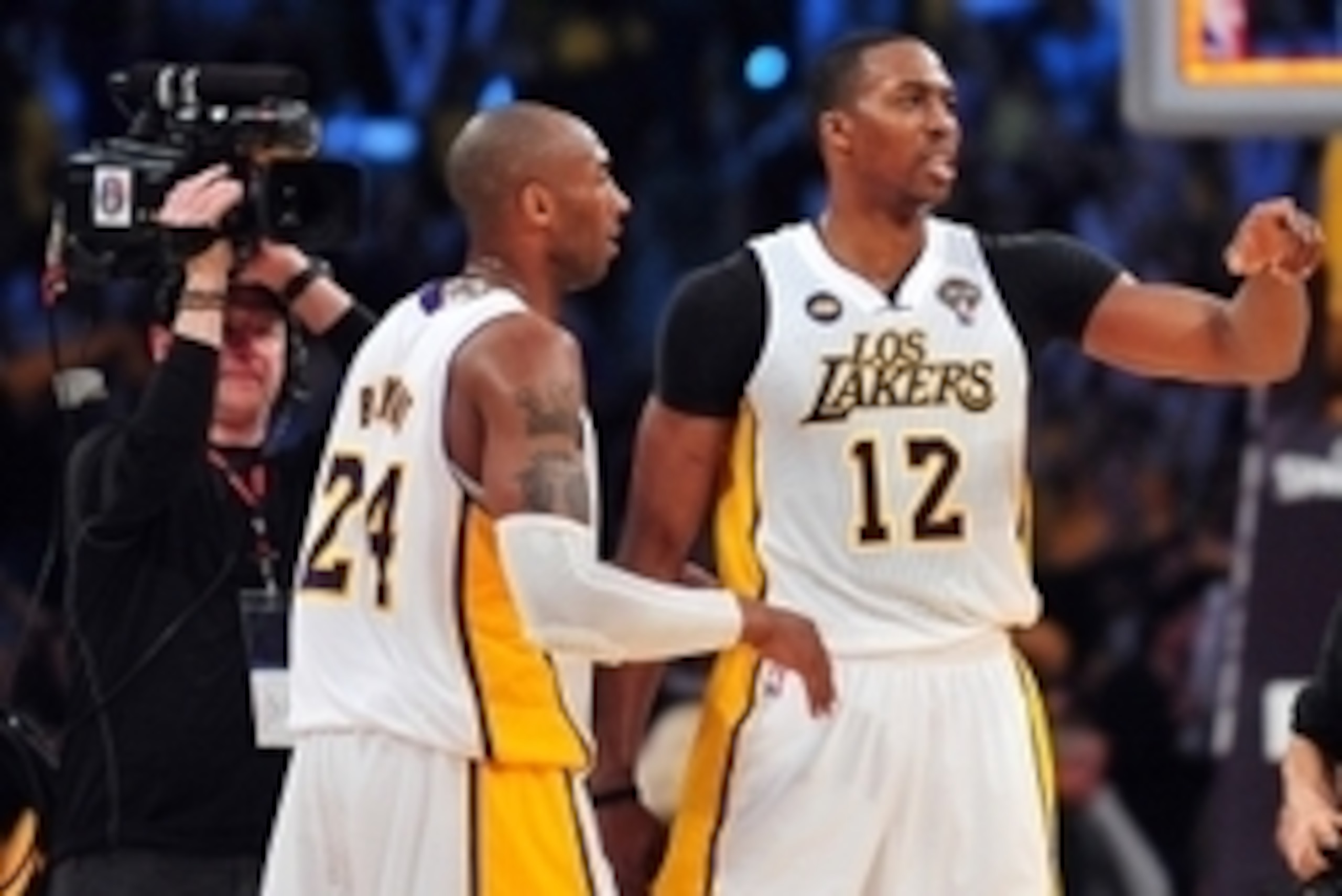 March 10, 2013; Los Angeles, CA, USA; Los Angeles /Lakers center Dwight Howard (12) celebrates the 90-81 victory with shooting guard Kobe Bryant (24) against the Chicago Bulls at Staples Center. Mandatory Credit: Gary A. Vasquez-USA TODAY Sports