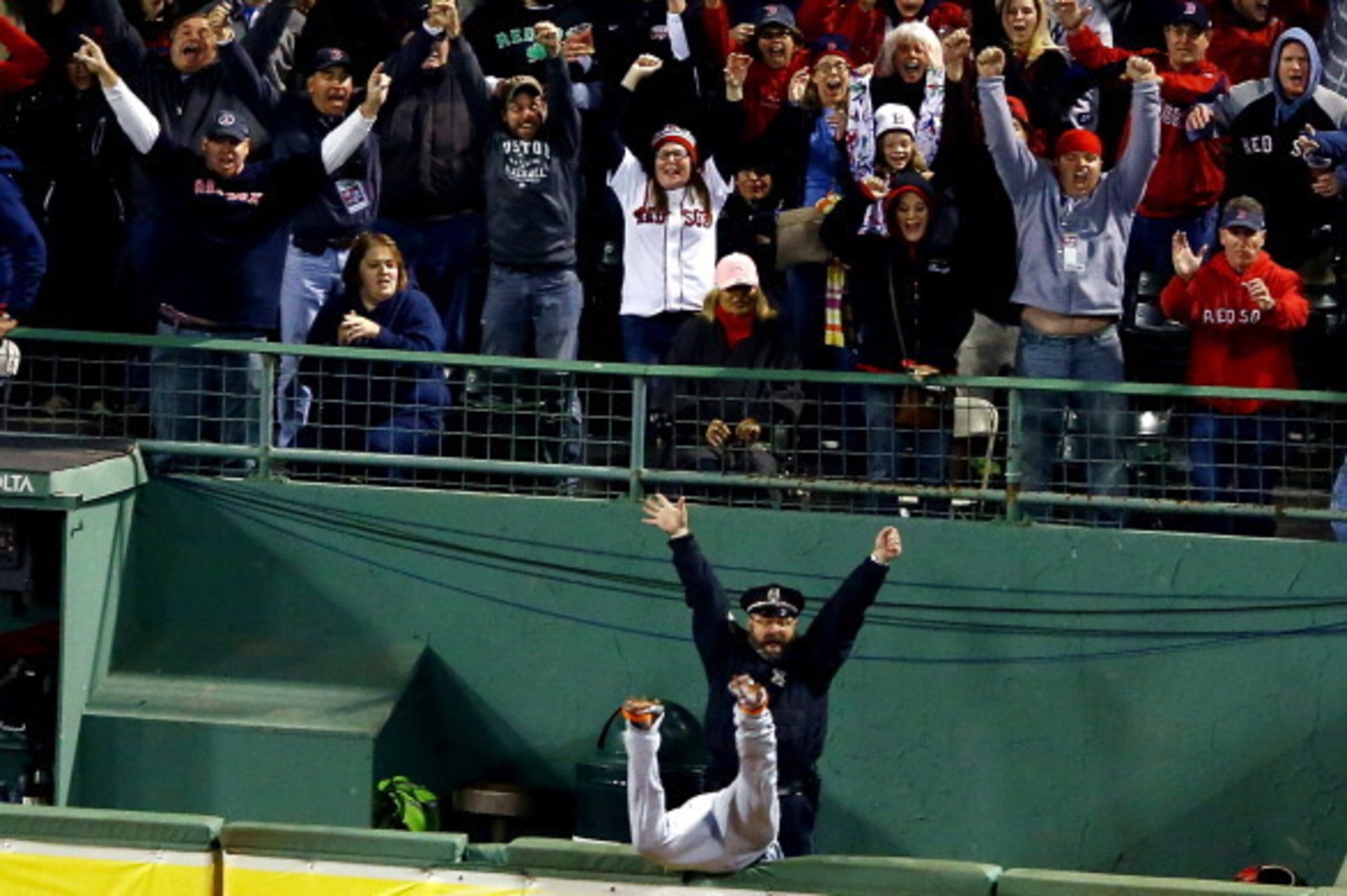 BOSTON, MA - OCTOBER 13: Boston police officer Steve Horgan reacts as Torii Hunter #48 of the Detroit Tigers tries to catch a grand slam hit by David Ortiz #34 of the Boston Red Sox in the eighth inning of Game Two of the American League Championship Seri
