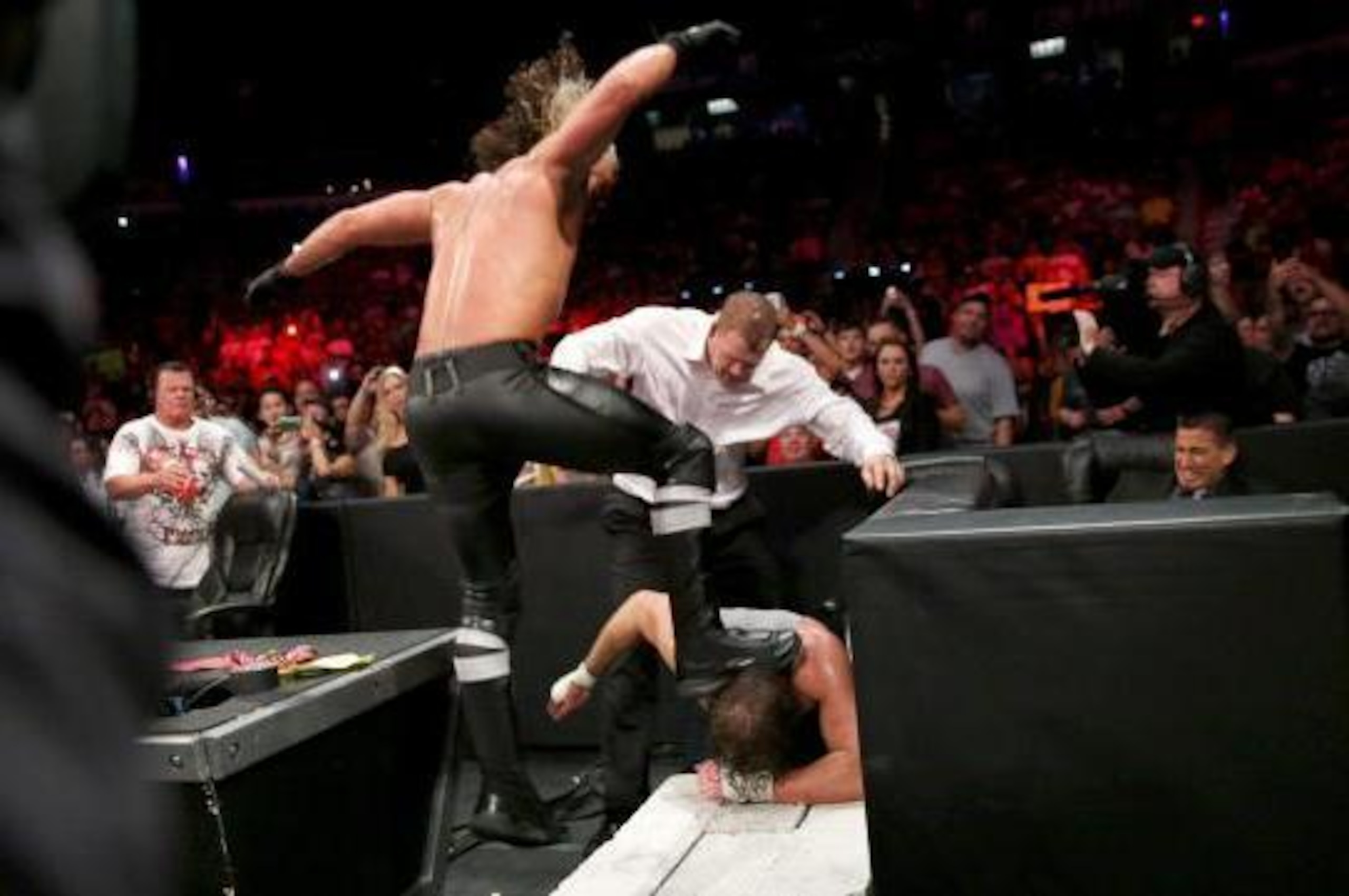 Seth Rollins stomps on Dean Ambrose.