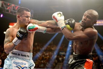 LAS VEGAS, NV - MAY 03:  (L-R) Marcos Maidana and  Floyd Mayweather Jr. exchange blows during their WBC/WBA welterweight unification fight at the MGM Grand Garden Arena on May 3, 2014 in Las Vegas, Nevada. Mayweather took Maidana's title with a majority-d