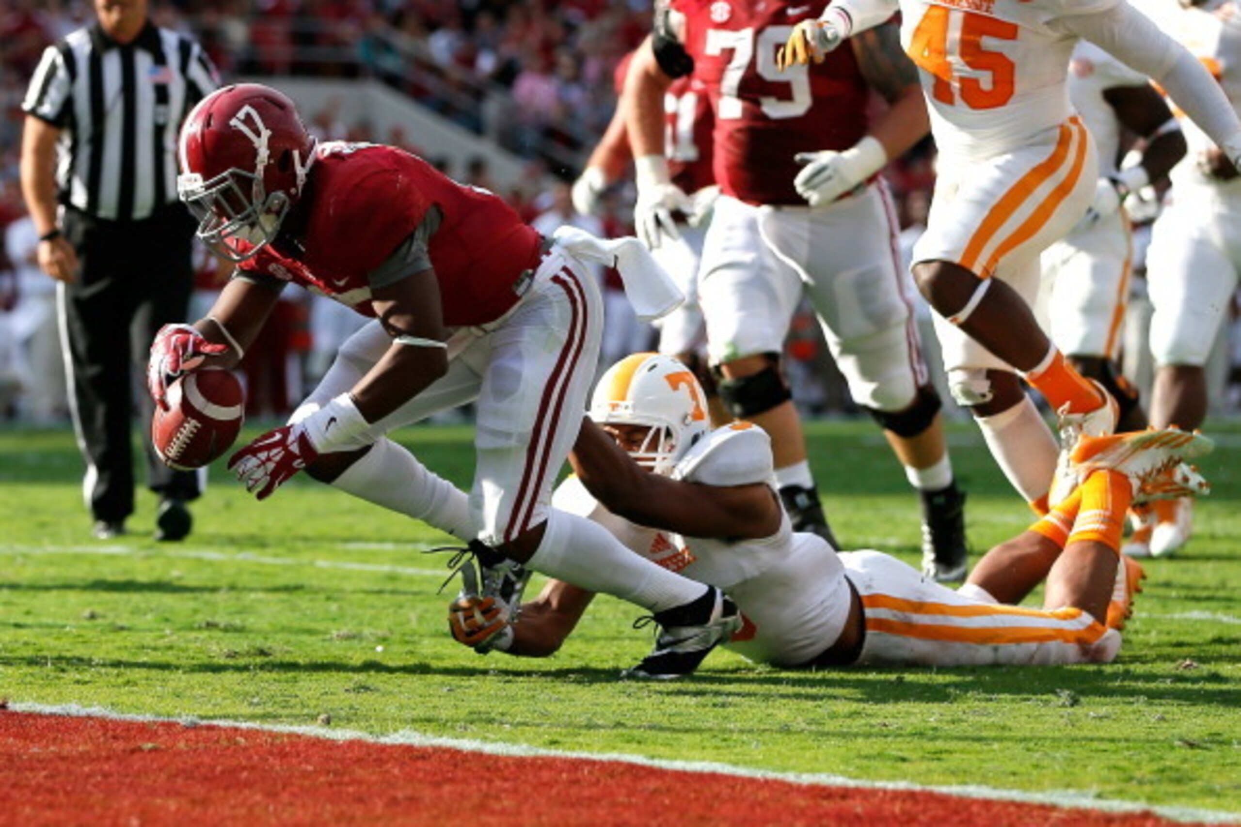 TUSCALOOSA, AL - OCTOBER 26:  Kenyan Drake #17 of the Alabama Crimson Tide fumbles the ball as he is tackled by Byron Moore #3 of the Tennessee Volunteers at Bryant-Denny Stadium on October 26, 2013 in Tuscaloosa, Alabama.  (Photo by Kevin C. Cox/Getty Im