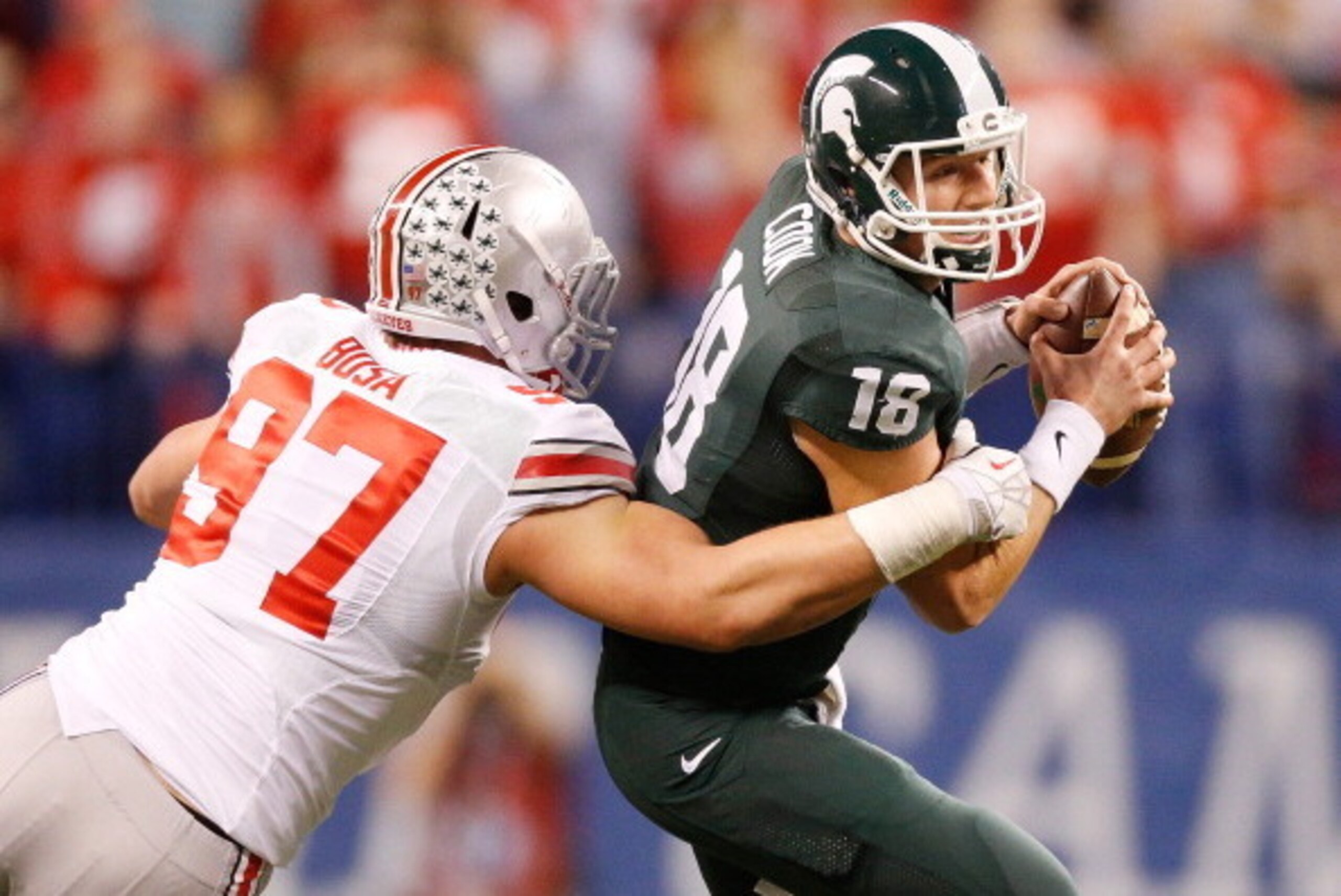 INDIANAPOLIS, IN - DECEMBER 07: Joey Bosa #97 of the Ohio State Buckeyes sacks Connor Cook #18 of the Michigan State Spartans in the first quarter during the Big 10 Conference Championship Game at Lucas Oil Stadium on December 7, 2013 in Indianapolis, In INDIANAPOLIS, IN - DECEMBER 07: Joey Bosa #97 of the Ohio State Buckeyes sacks Connor Cook #18 of the Michigan State Spartans in the first quarter during the Big 10 Conference Championship Game at Lucas Oil Stadium on December 7, 2013 in Indianapolis, In