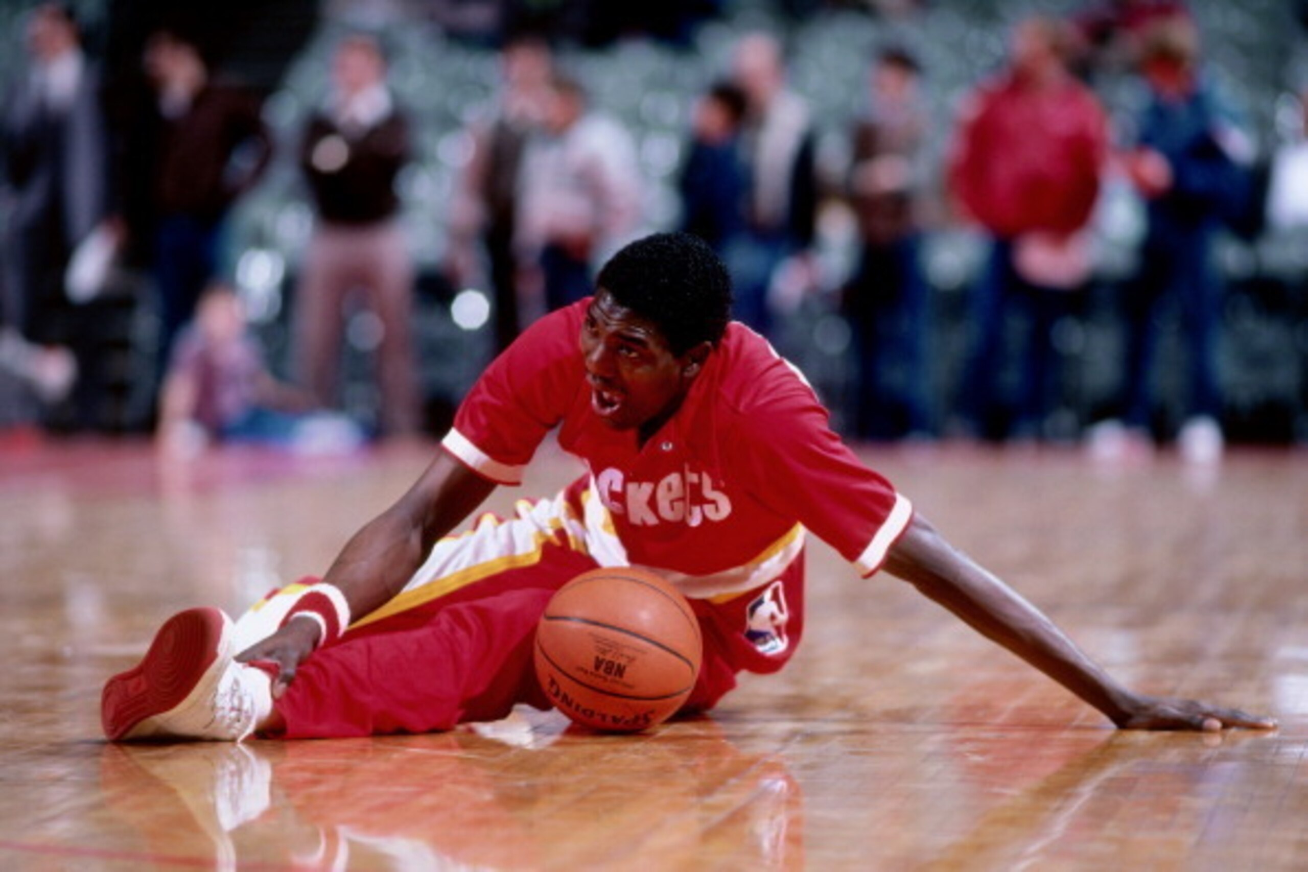 PORTLAND, OR - 1985: Hakeem Olajuwon #34 of the Houston Rockets stretches against the Portland Trailblazers circa 1985 at the Veterans Memorial Coliseum in Portland, Oregon. NOTE TO USER: User expressly acknowledges and agrees that, by downloading and or 