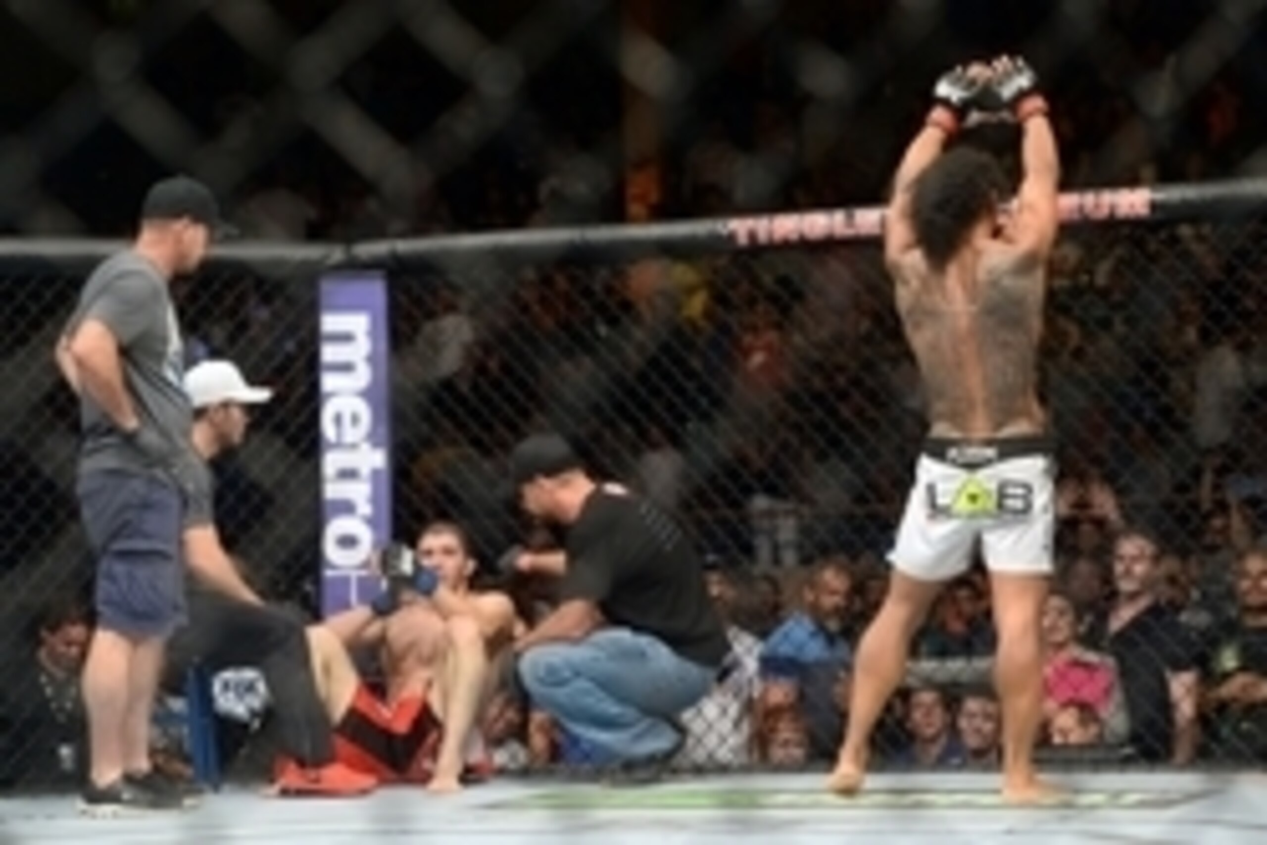 Jun 7, 2014; Albuquerque, NM, USA; Benson Henderson (red) celebrates his victory over Rustam Khabilov (blue) after their lightweight bout during UFC Fight Night 42 at Tingley Coliseum. Henderson won via fourth round submission. Mandatory Credit: Joe Campo