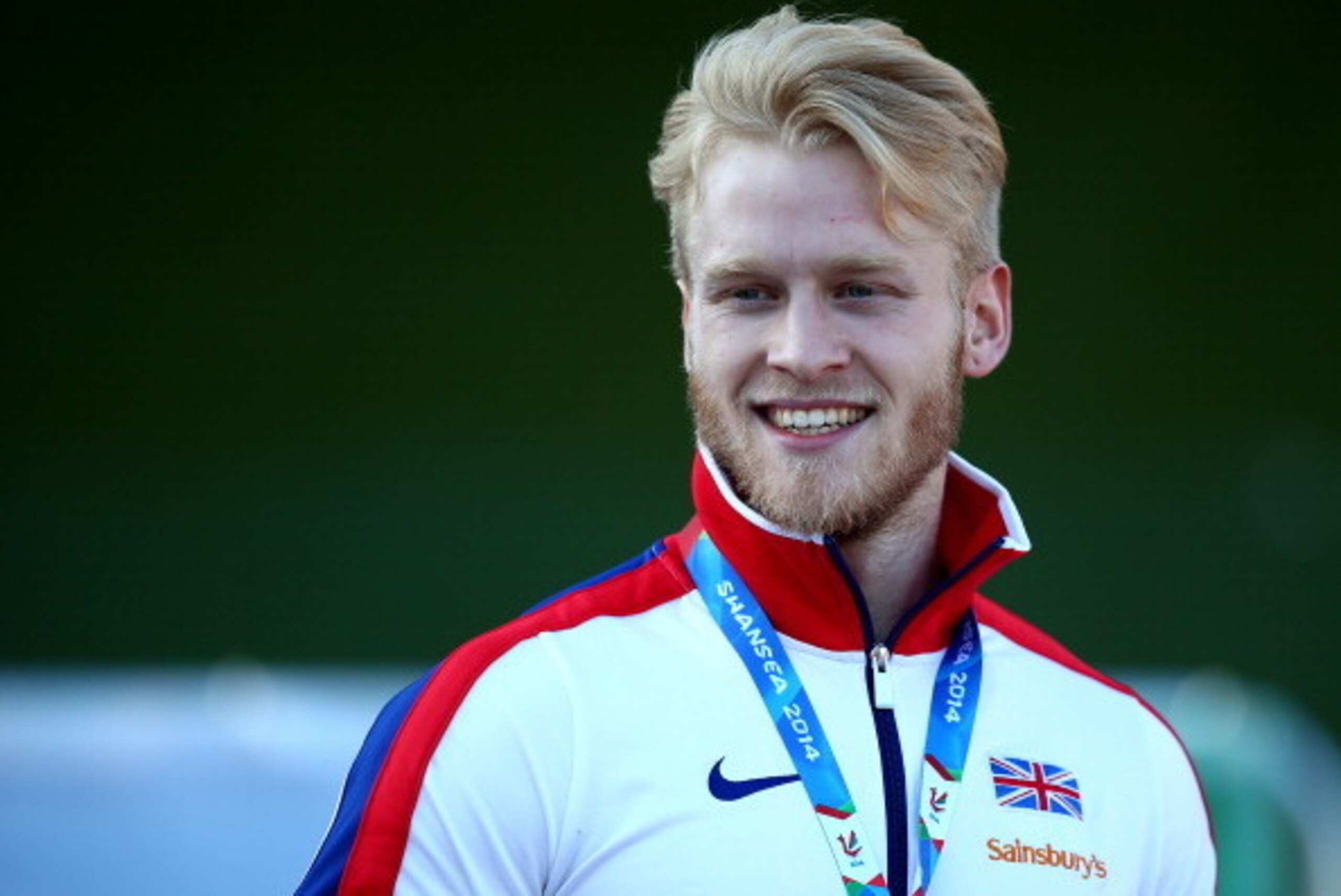 SWANSEA, WALES - AUGUST 19: Jonnie Peacock of Great Britain with his gold medal after winning mens 100m T44 final during day one of the IPC Athletics European Championships at Swansea University Sports Village on August 19, 2014 in Swansea, Wales. (Photo 