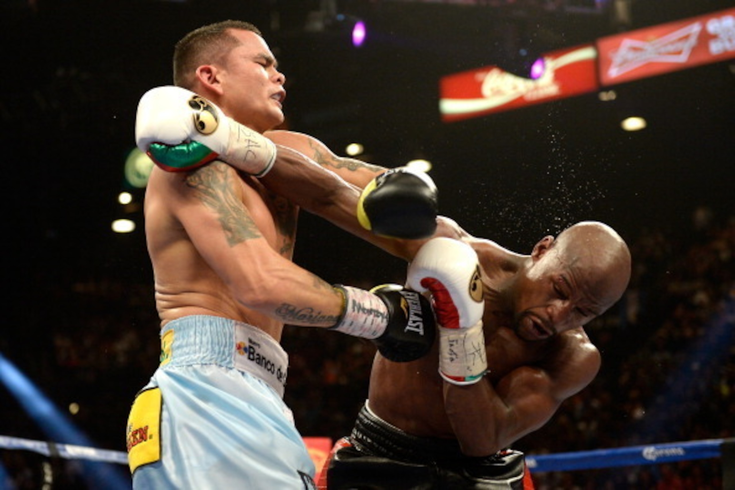 LAS VEGAS, NV - MAY 03:  (L-R) Marcos Maidana and Floyd Mayweather Jr. exchange blows during their WBC/WBA welterweight unification fight at the MGM Grand Garden Arena on May 3, 2014 in Las Vegas, Nevada.  (Photo by Harry How/Getty Images)