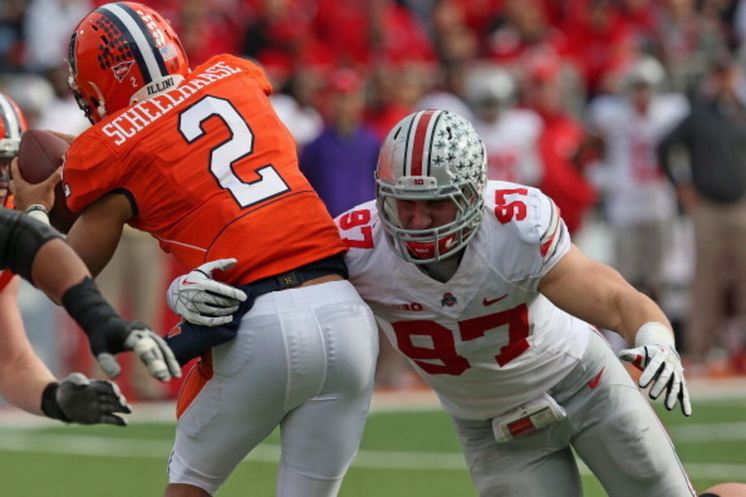 CHAMPAIGN, IL - NOVEMBER 16: Joey Bosa #97 of the Ohio State Buckeyes hits Nathan Scheelhaase #2 of the Illinois Fighting Illini at Memorial Stadium on November 16, 2013 in Champaign, Illinois. Ohio State defeated Illinois 60-35. (Photo by Jonathan Daniel