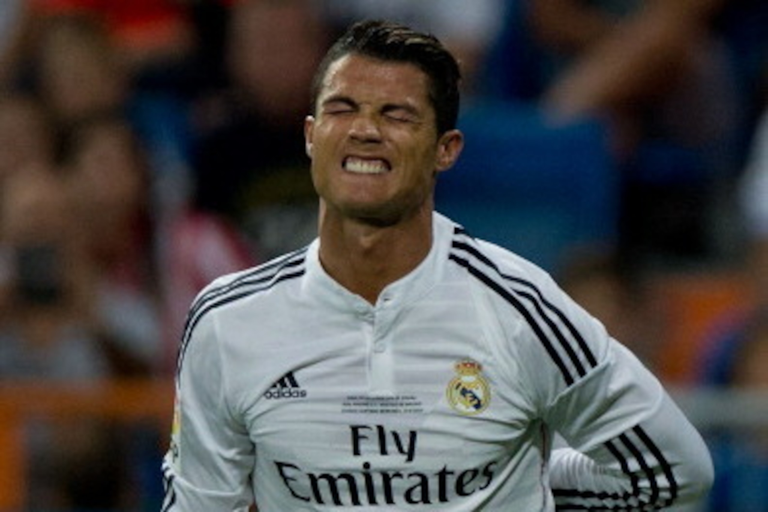 MADRID, SPAIN - AUGUST 19:  Cristiano Ronaldo of Real Madrid CF grimaces in pain during the Supercopa first leg match between Real Madrid and Club Atletico de Madrid at Estadio Santiago Bernabeu on August 19, 2014 in Madrid, Spain.  (Photo by Gonzalo Arro
