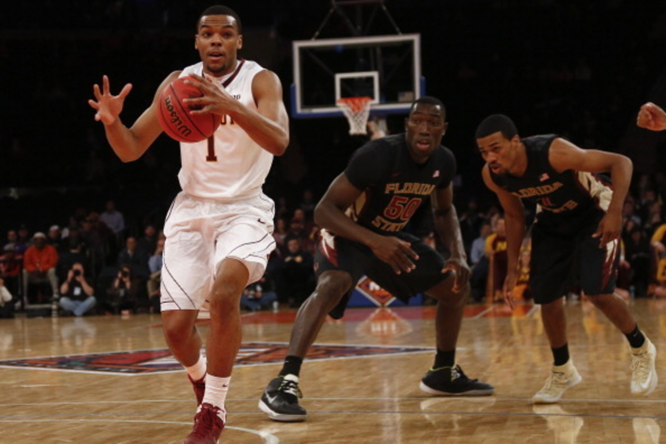 NEW YORK, NY - APRIL 1: Andre Hollins #1 of the Minnesota Golden Gophers drives by Michael Ojo #50 of the Florida State Seminoles during the NIT Championship semifinals at Madison Square Garden on April 1, 2014 in New York City. (Photo by Jeff Zelevans NEW YORK, NY - APRIL 1: Andre Hollins #1 of the Minnesota Golden Gophers drives by Michael Ojo #50 of the Florida State Seminoles during the NIT Championship semifinals at Madison Square Garden on April 1, 2014 in New York City. (Photo by Jeff Zelevans