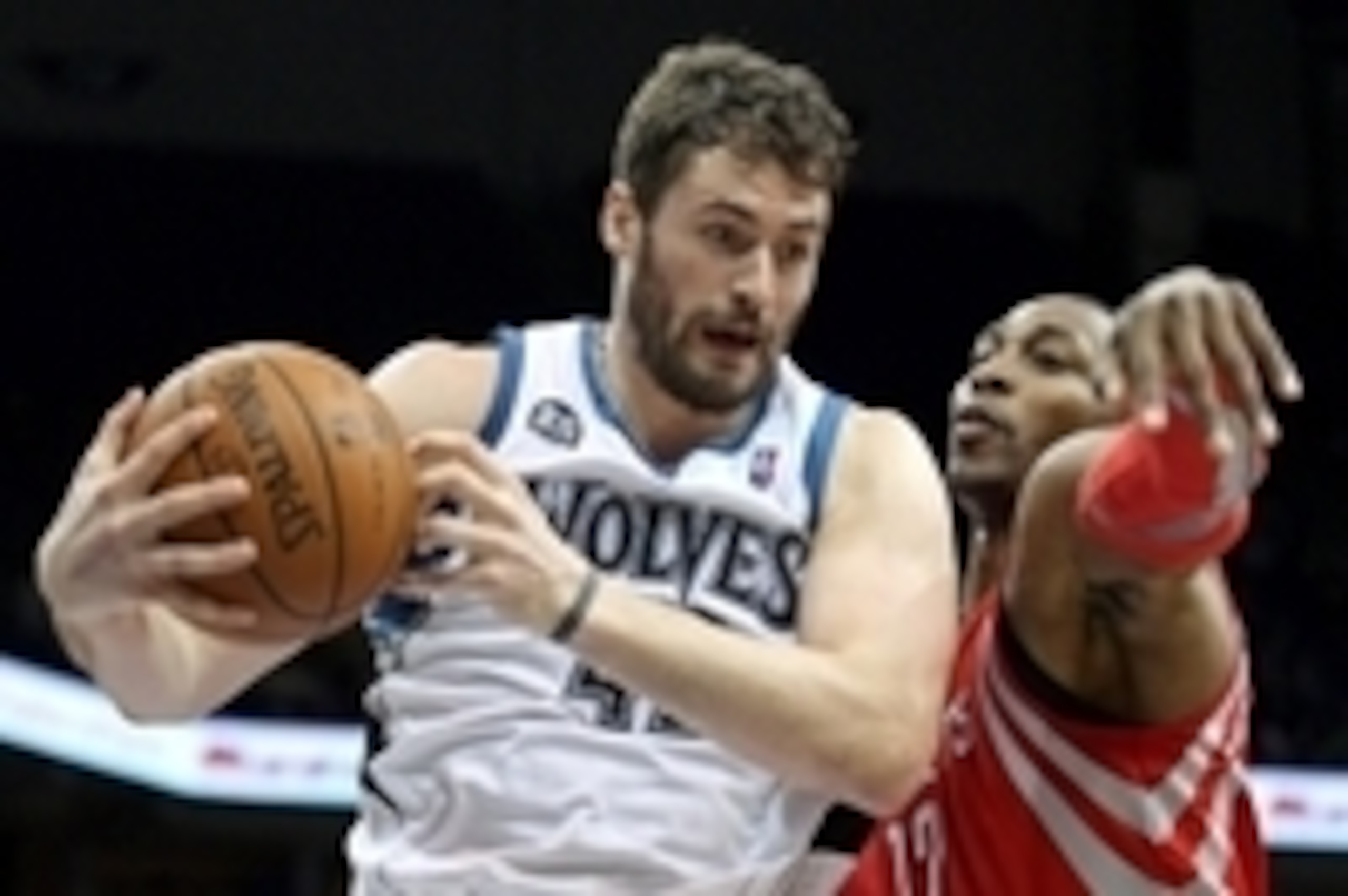 Feb 10, 2014; Minneapolis, MN, USA; Minnesota Timberwolves forward Kevin Love (42) grabs a rebound over Houston Rockets center Dwight Howard (12) during the second quarter at Target Center. Mandatory Credit: Brace Hemmelgarn-USA TODAY Sports