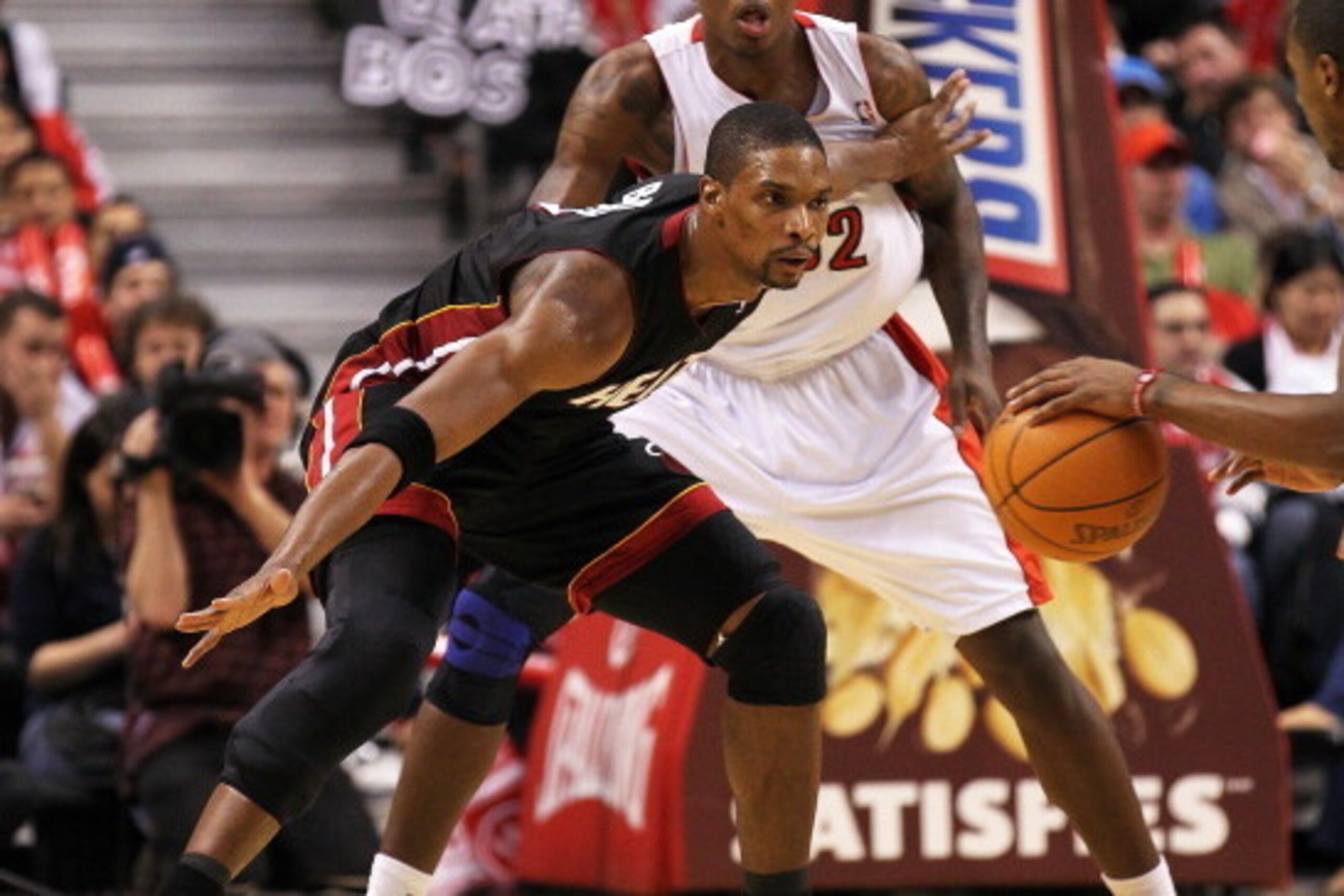 TORONTO, CAN - FEBRUARY 16:  Chris Bosh #1 of the Miami Heat plays a block against Ed Davis #32 of the Toronto Raptors in a game on February 16, 2011 at the Air Canada Centre in Toronto, Canada. The Heat defeated the Raptors 103-95. (Photo by Claus Anders