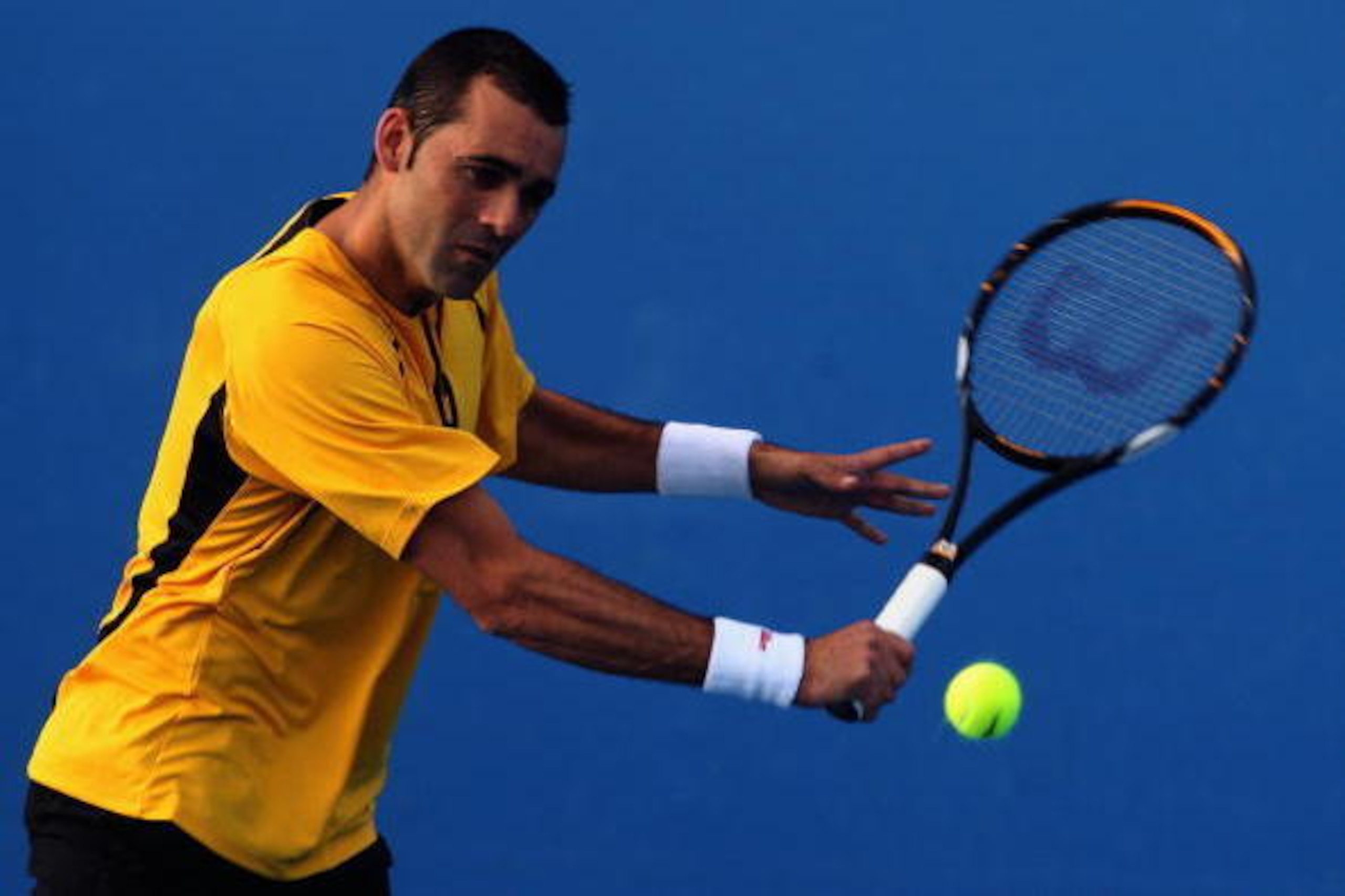 MELBOURNE, AUSTRALIA - JANUARY 19:  Oscar Hernandez of Germany plays a backhand in his first round match against Albert Montanes of Spain during day two of the 2010 Australian Open at Melbourne Park on January 19, 2010 in Melbourne, Australia.  (Photo by 