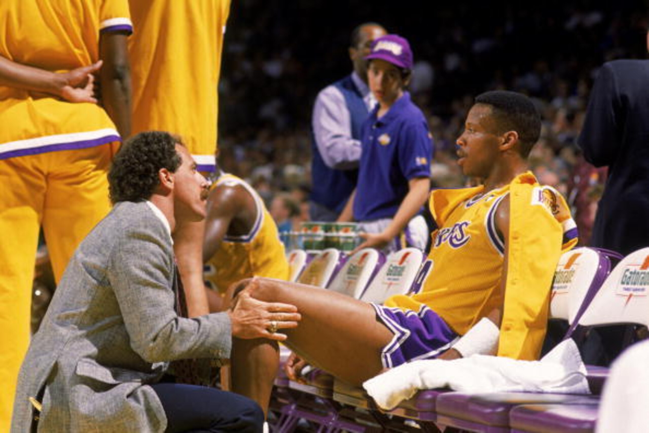 LOS ANGELES - 1989:  Head trainer Gary Vitti of the Los Angeles Lakers attends to Byron Scott #4 on the bench during an NBA game at the Great Western Forum in Los Angeles, California in 1989. (Photo by: Ken Levine/Getty Images)