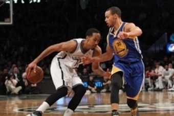 Jan 8, 2014; Brooklyn, NY, USA; Brooklyn Nets point guard Shaun Livingston (14) controls the ball in front of Golden State Warriors point guard Stephen Curry (30) during the fourth quarter of a game at Barclays Center. The Nets defeated the Warriors 102-9