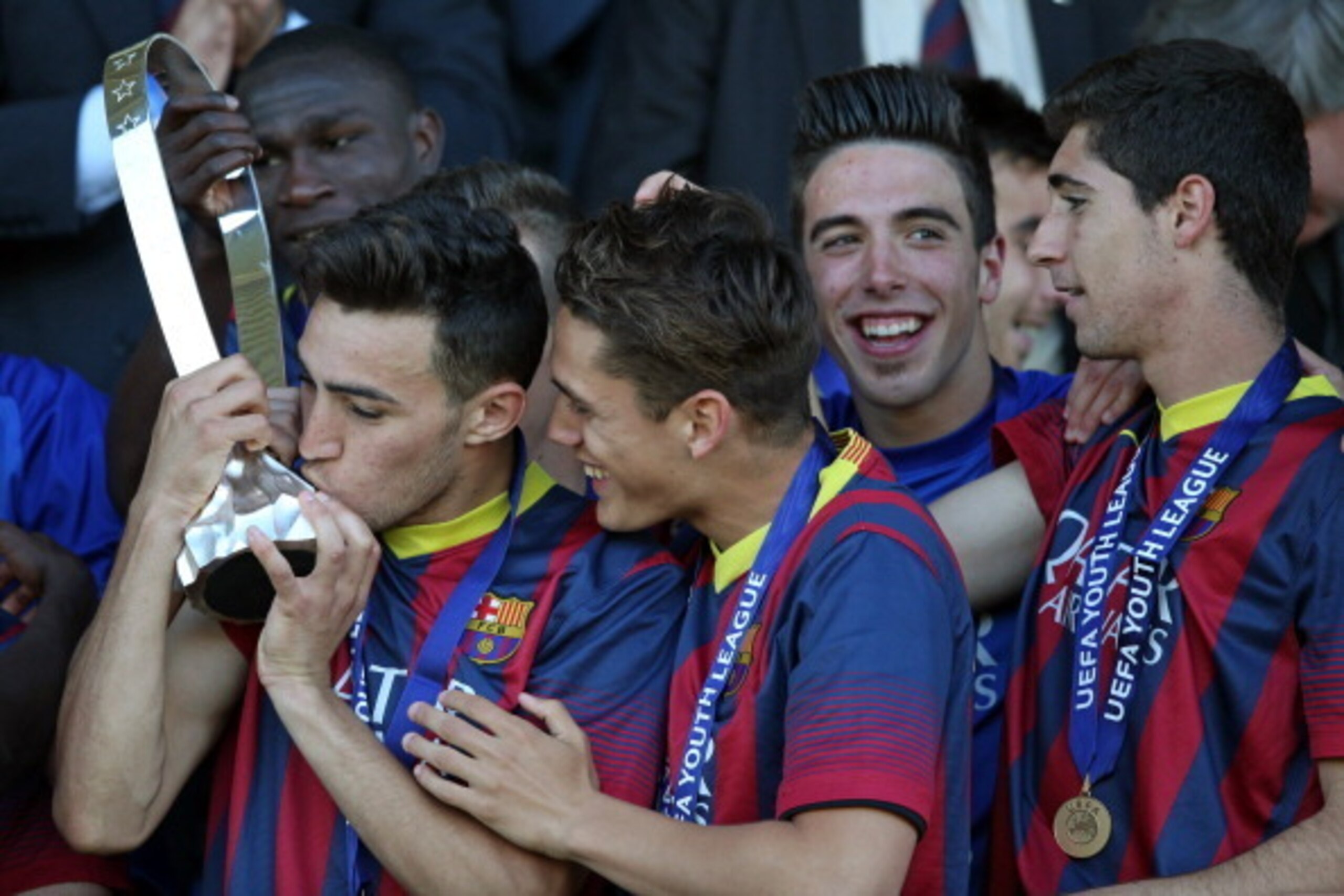 NYON, SWITZERLAND - APRIL 14: Munir El Haddadi of FC Barcelona (L) kisses the Lennart Johansson trophy after winning the UEFA Youth League Final match between Benfica Lisbon and FC Barcelona at Colovray Stadion on April 14, 2014 in Nyon, Switzerland. (Pho