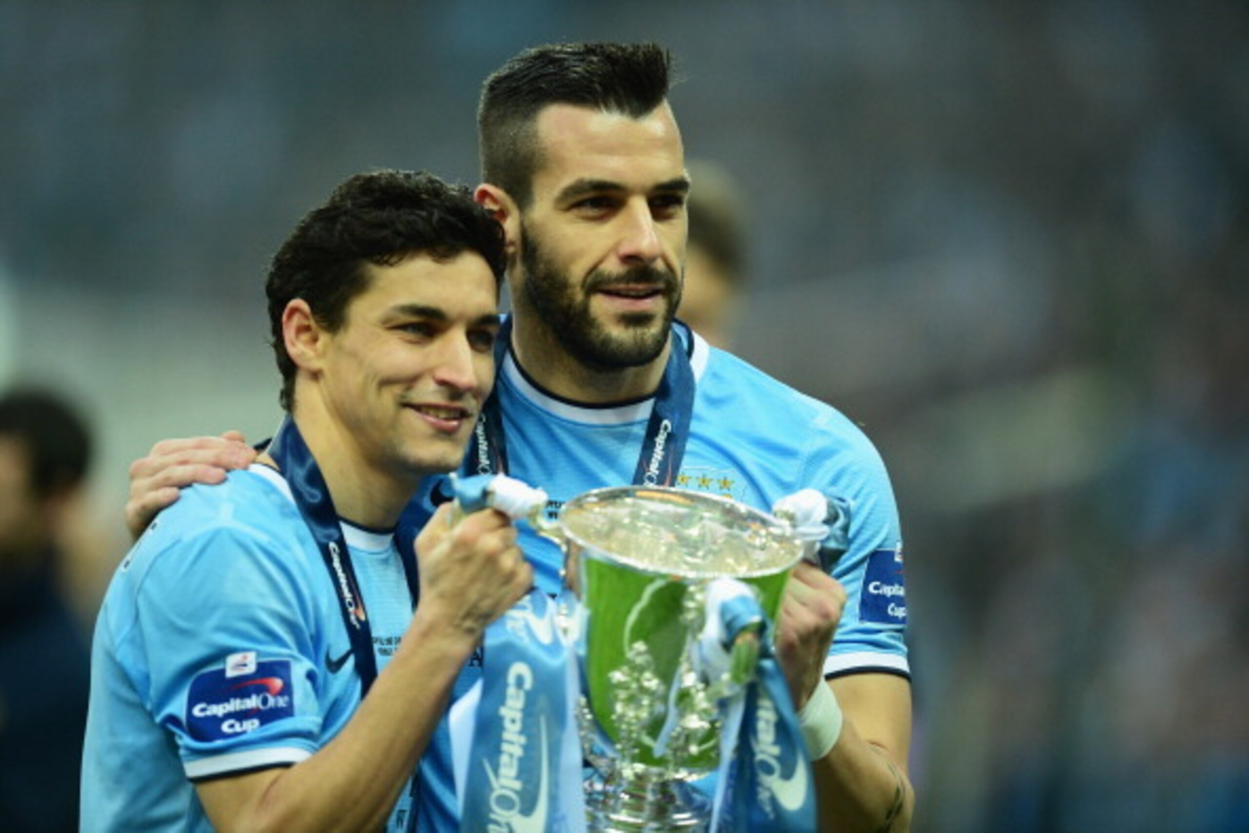 LONDON, ENGLAND - MARCH 02:  (L-R) Jesus Navas and Alvaro Negredo of Manchester City pose with the trophy after the Capital One Cup Final between Manchester City and Sunderland at Wembley Stadium on March 2, 2014 in London, England.  (Photo by Jamie McDon
