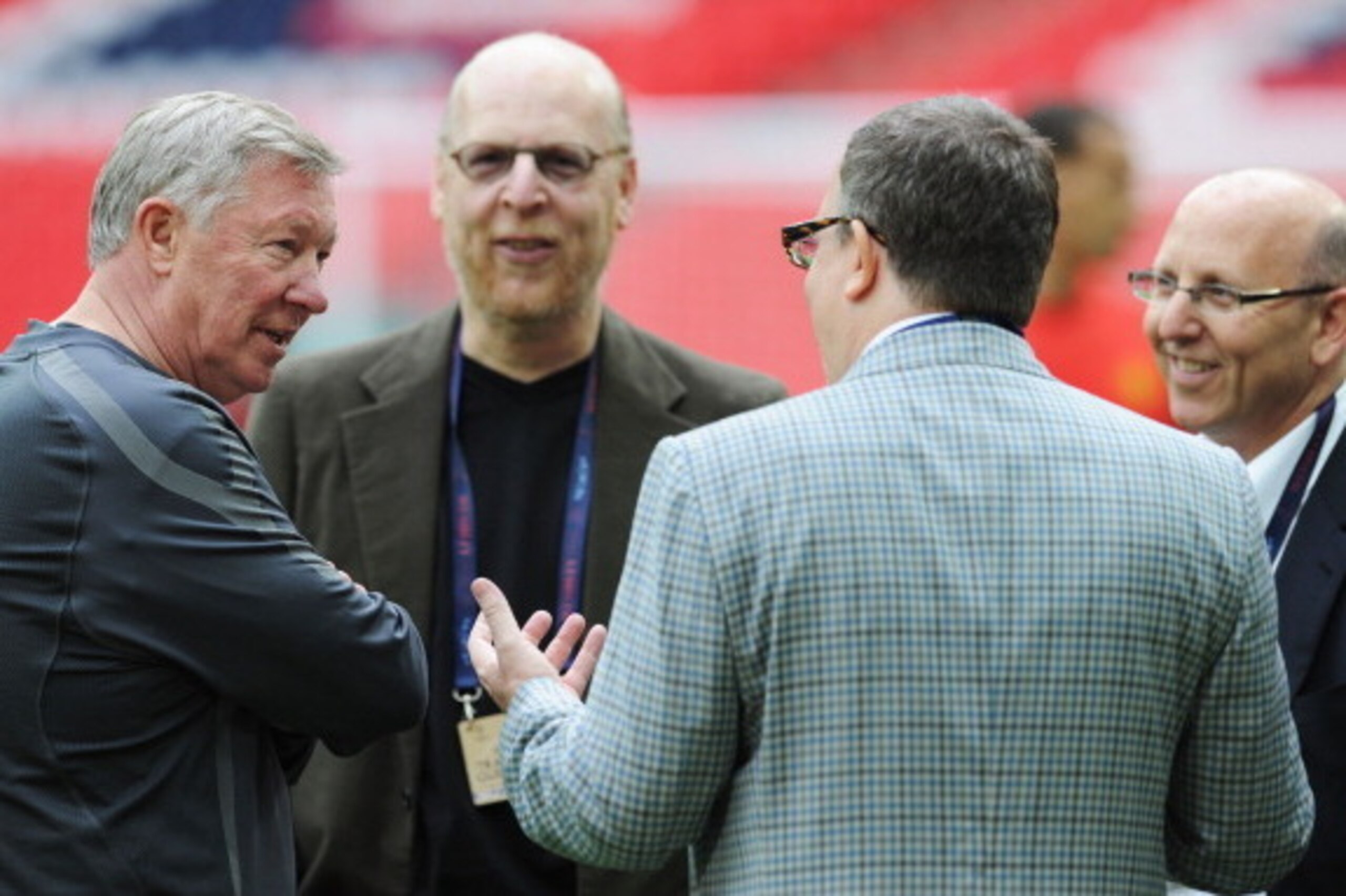 LONDON, ENGLAND - MAY 27:  Sir Alex Ferguson manager of Manchester United (L) speaks with Avram Glazer (2L), Bryan Glazer (2R) and Joel Glazer (R) during a Manchester United training session prior to the UEFA Champions League final versus Barcelona at Wem