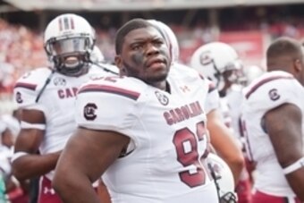 Oct 12, 2013; Fayetteville, AR, USA; South Carolina Gamecock defensive tackle Gerald Dixon Jr. (92) looks up from the sidelines during a game against the Arkansas Razorbacks at Donald W. Reynolds Razorback Stadium. South Carolina defeated Arkansas 52-7. M