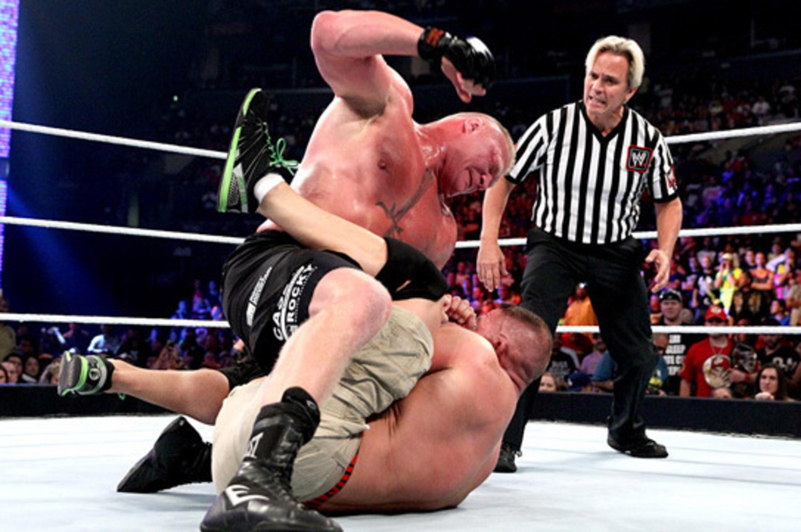 Brock Lesnar beats on John Cena.