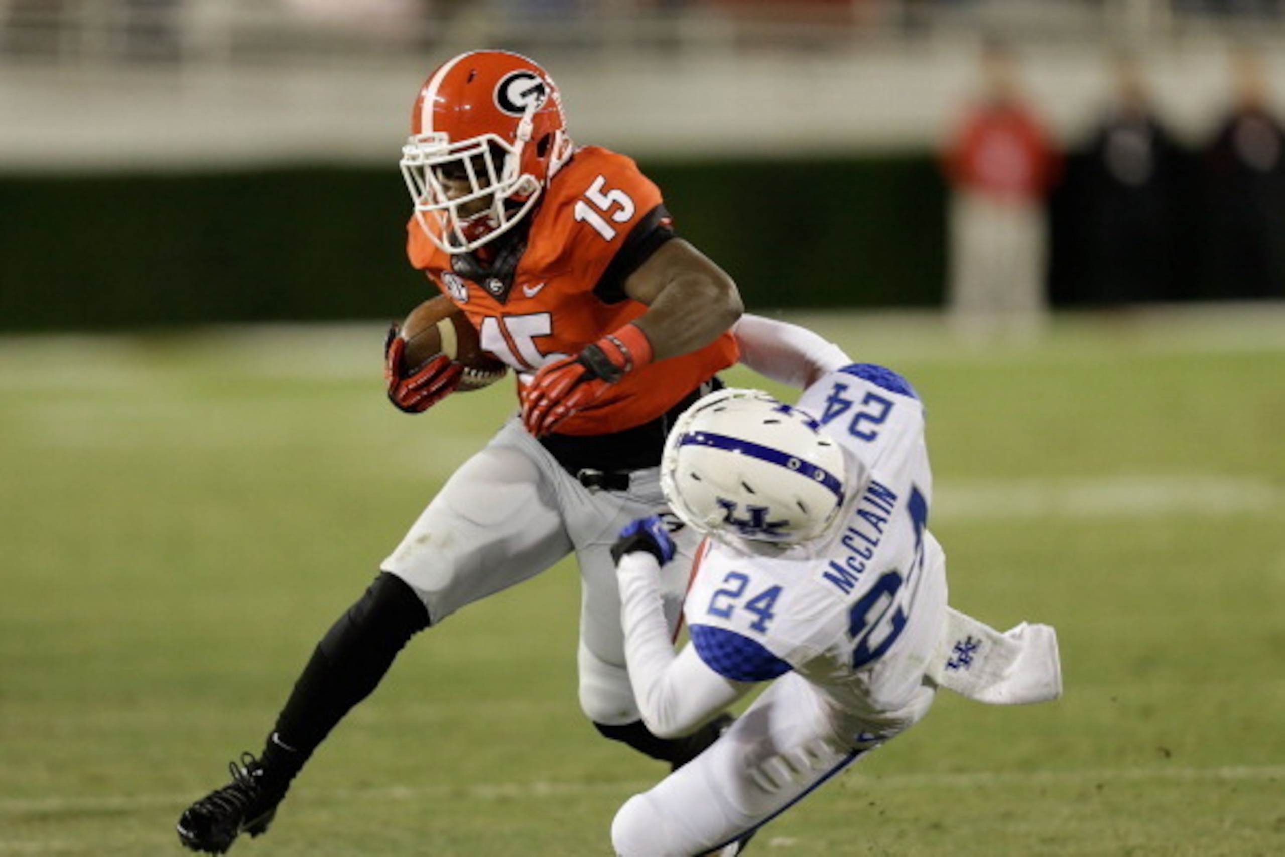 ATHENS, GA - NOVEMBER 23:  Running back J.J. Green #15 of the Georgia Bulldogs runs over defensive back Blake McClain #24 of the Kentucky Wildcats during the game at Sanford Stadium on November 23, 2013 in Athens, Georgia.  (Photo by Mike Zarrilli/Getty I