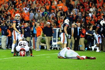 AUBURN, AL - NOVEMBER 16: Defensive Backs Corey Moore #39 and Tray Matthews #28 of the Georgia Bulldogs lie on the ground stunned after giving up the go-ahead touchdown against the Auburn Tigers at Jordan-Hare Stadium on November 16, 2013 in Auburn Alabam