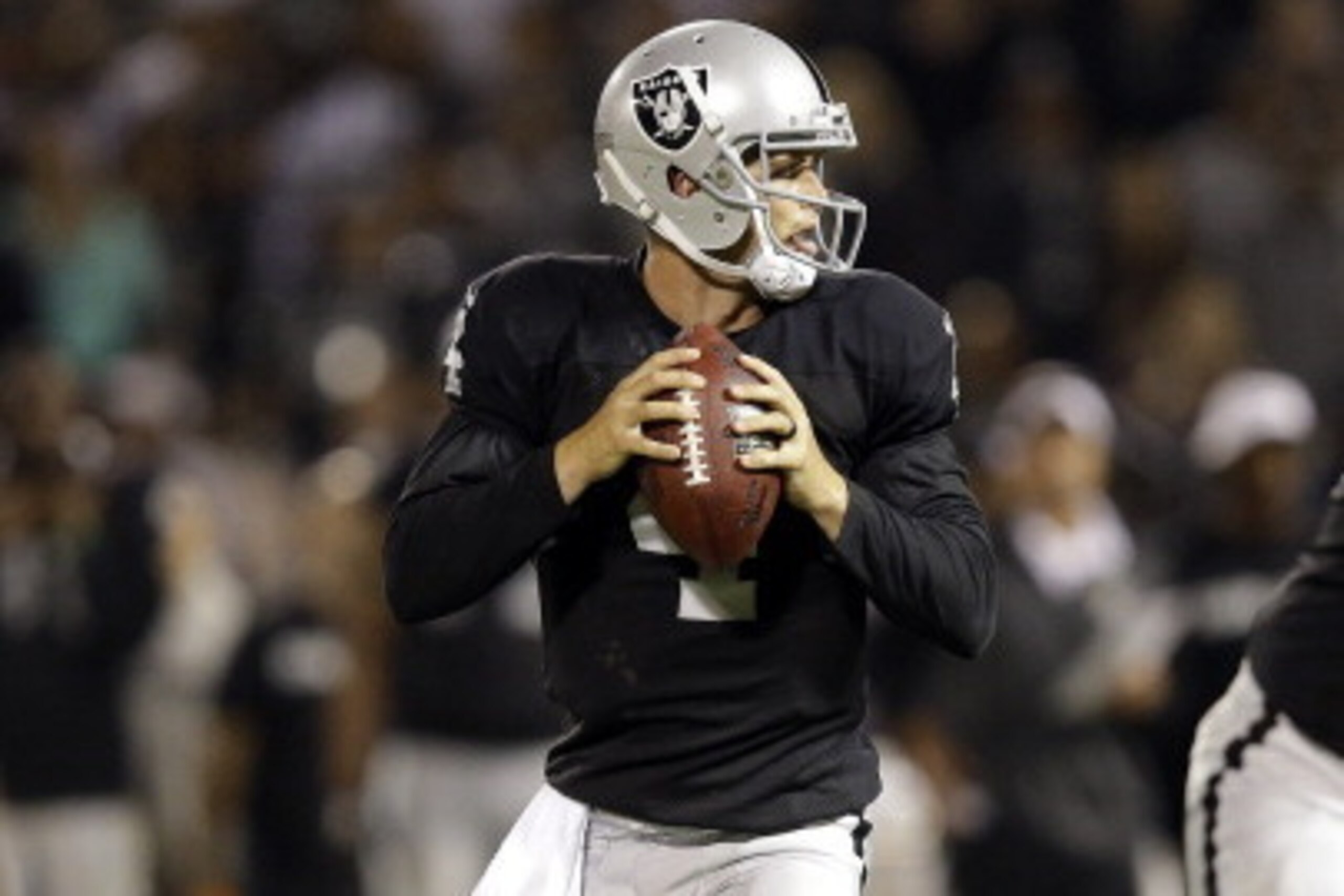 OAKLAND, CA - AUGUST 15:  Derek Carr #4 of the Oakland Raiders in action against the Detroit Lions during their preseason game at O.co Coliseum on August 15, 2014 in Oakland, California.  (Photo by Ezra Shaw/Getty Images)
