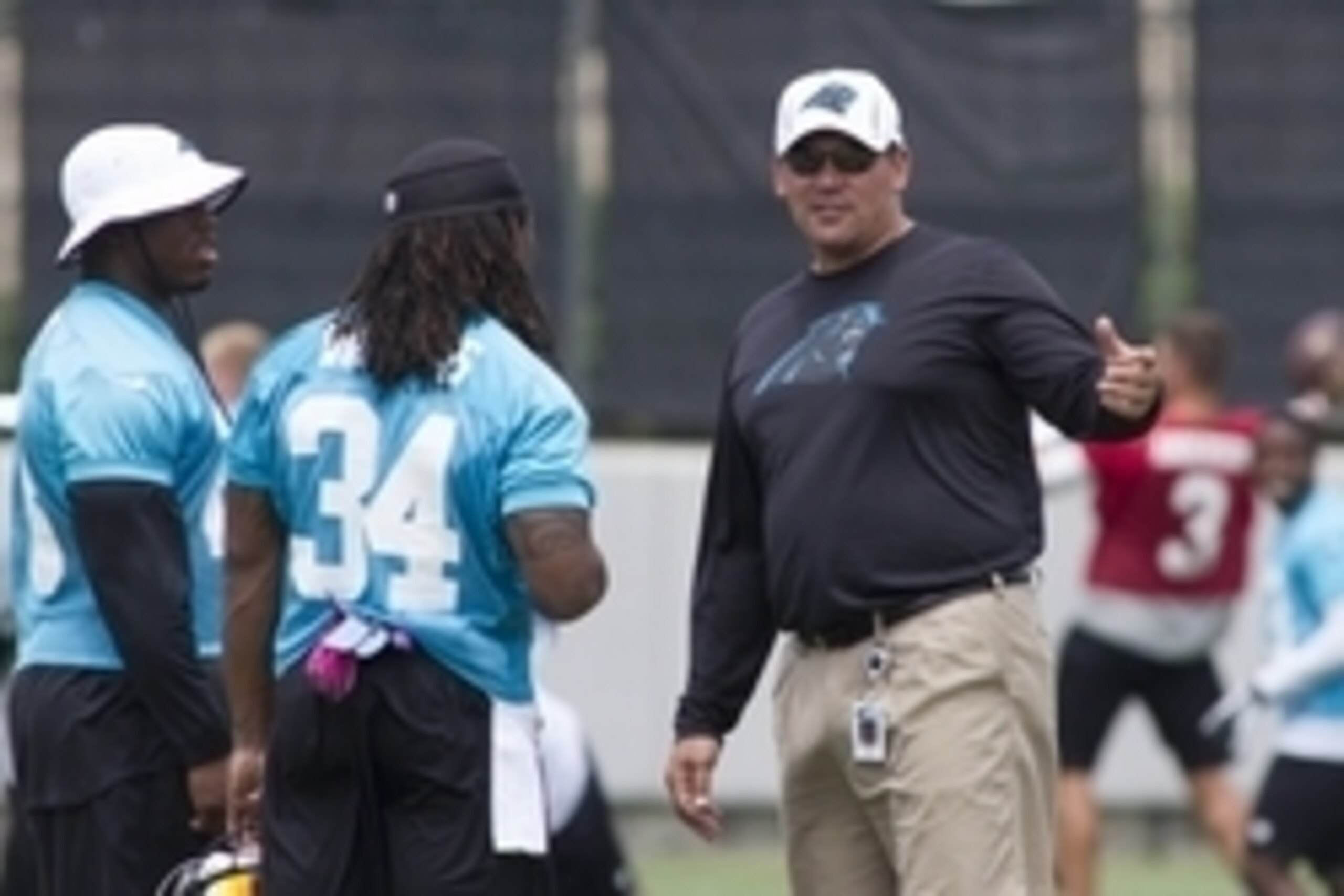 Jun 12, 2013; Charlotte, NC, USA; Carolina Panthers head coach Ron Rivera talks with DeAngelo Williams (34) and Jonathan Stewart (28) before the start of practice held at the Panthers practice facility. Mandatory Credit: Jeremy Brevard-USA TODAY Sports