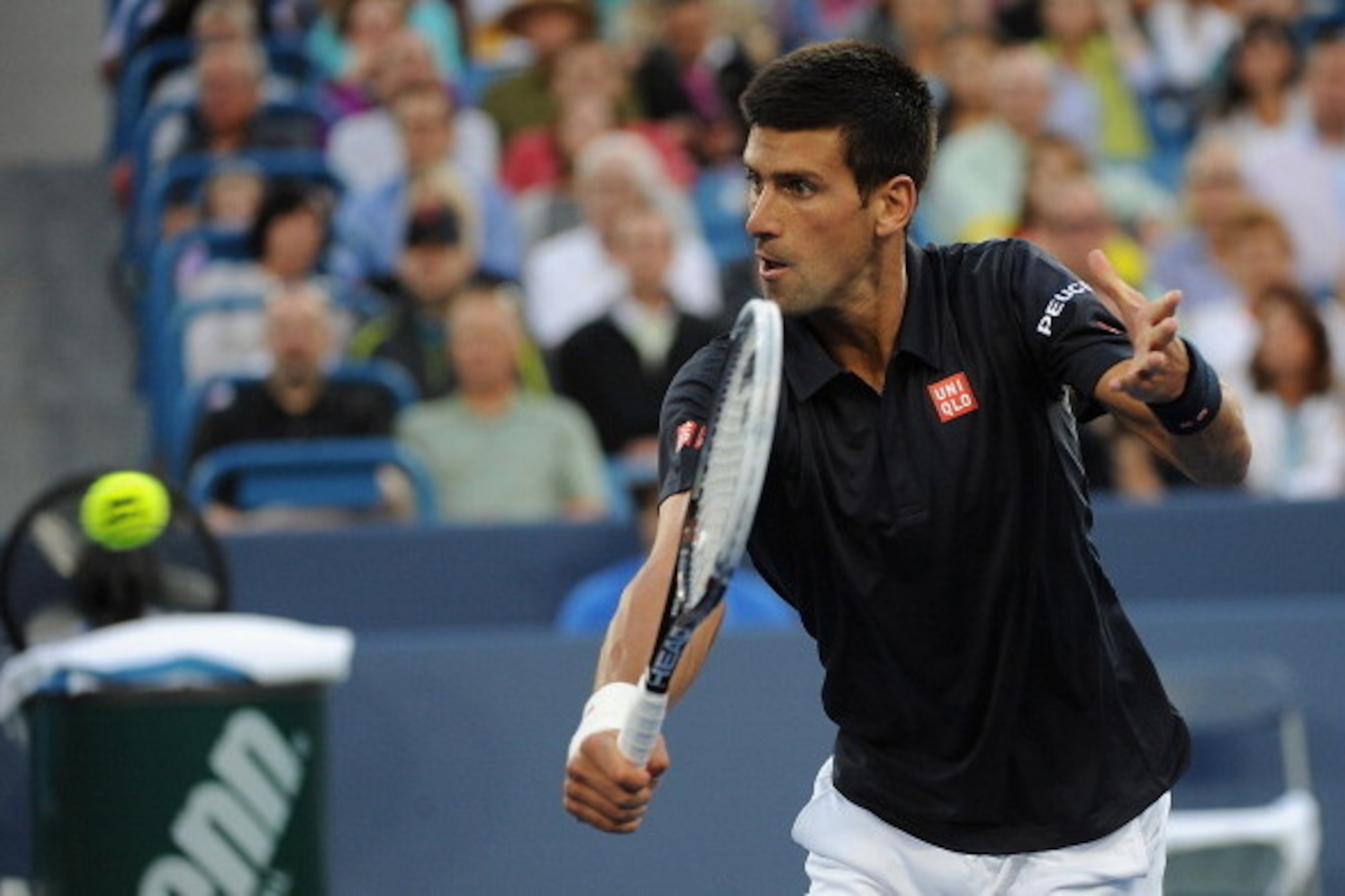 CINCINNATI, OH - AUGUST 12:  Novak Djokovic of Serbia returns to Gilles Simon of France during a match on day 4 of the Western & Southern Open on August 12, 2014 in Cincinnati, Ohio.  (Photo by Jonathan Moore/Getty Images)